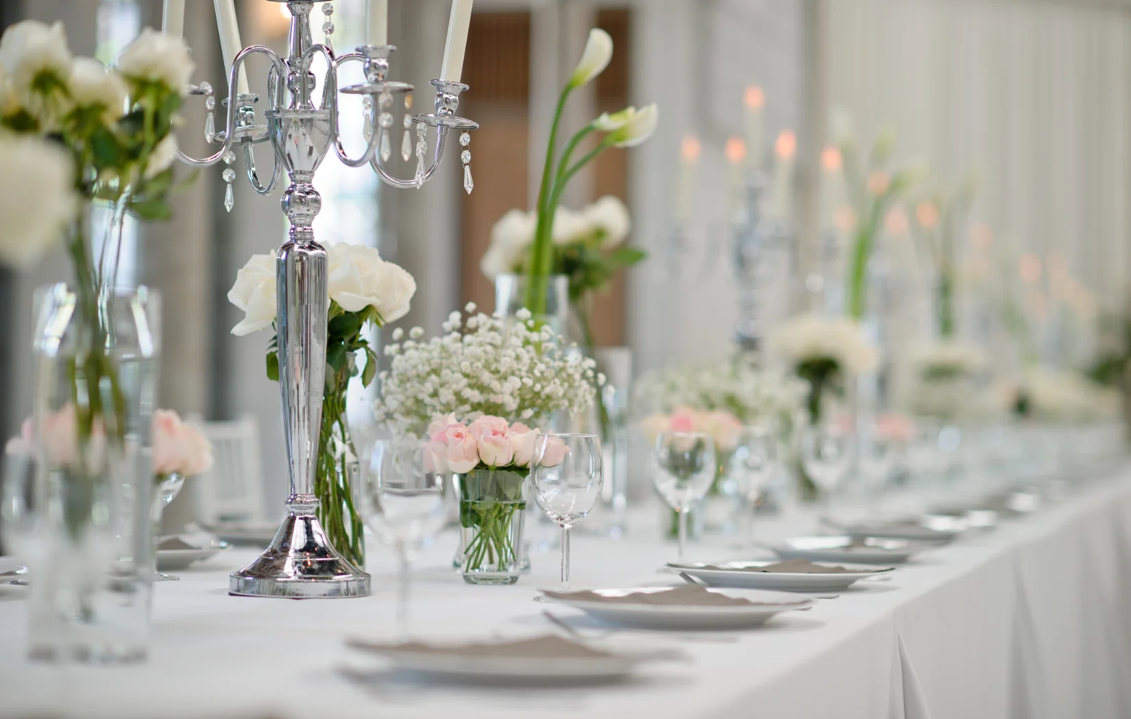 Elegant wedding reception table setting with floral arrangements
