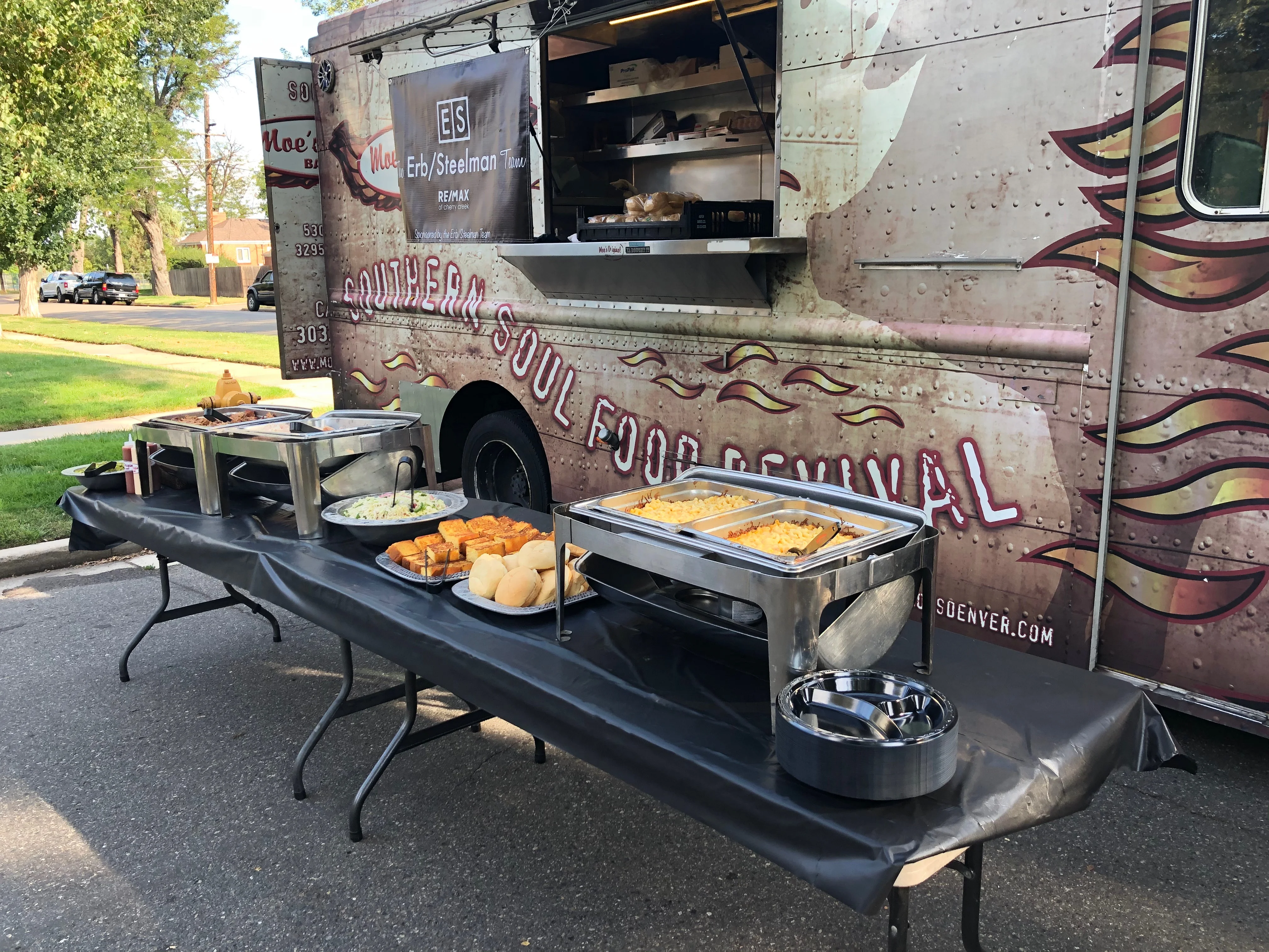 Food truck serving Southern soul food with buffet setup outdoors.