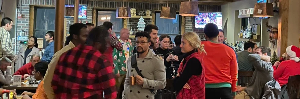Lively restaurant interior with patrons enjoying drinks and conversation