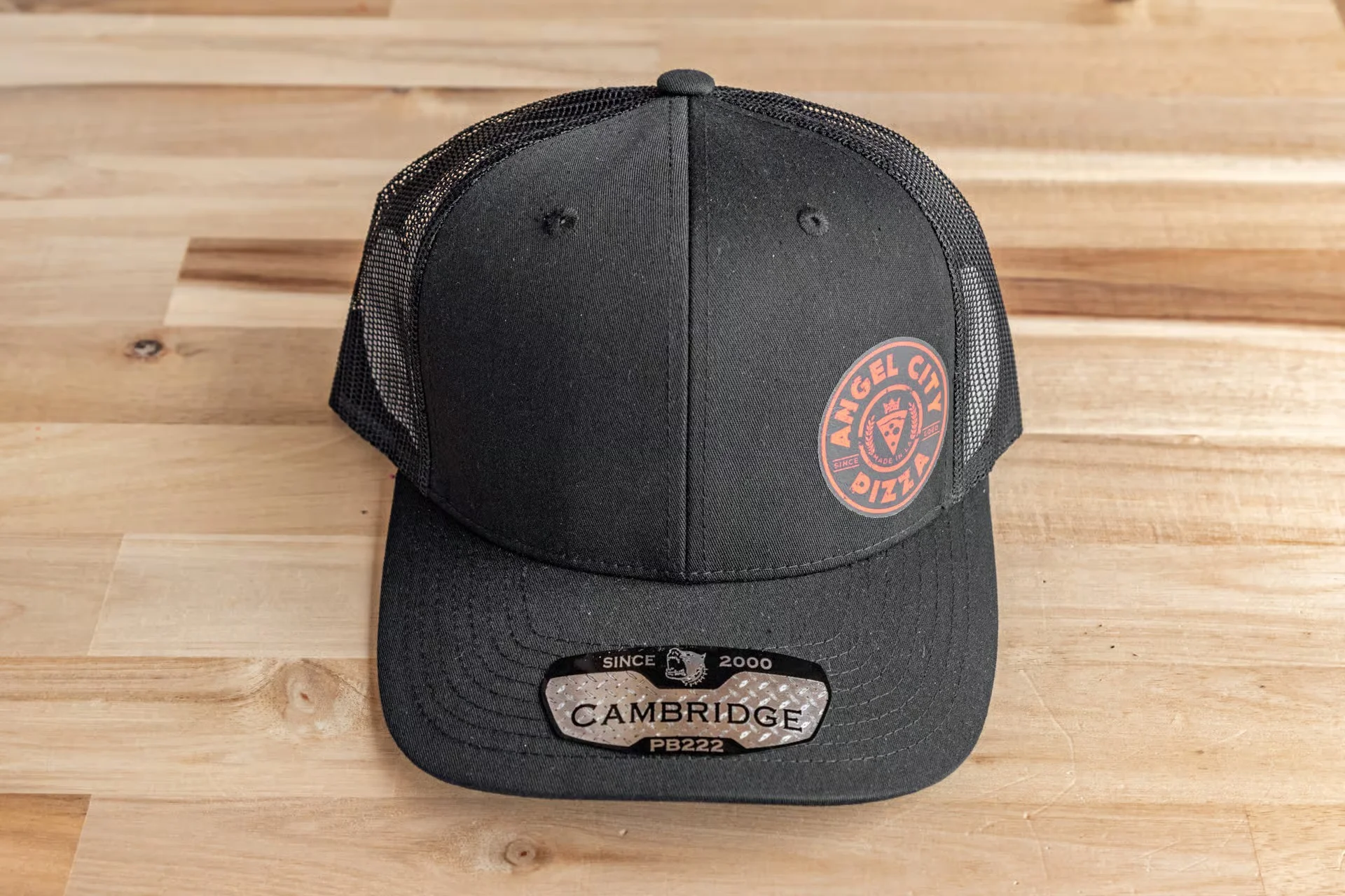 Black trucker hat with Angel City Pizza logo