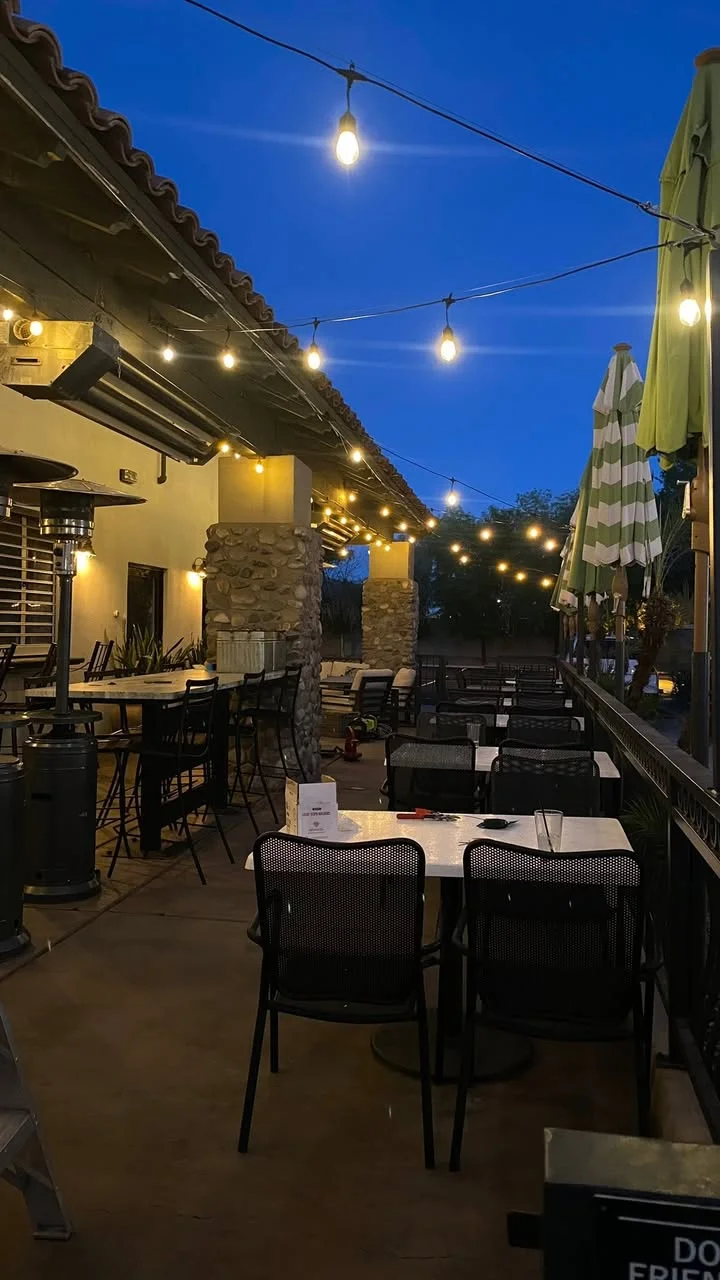 evening patio pictures with lights and tables and bar stools