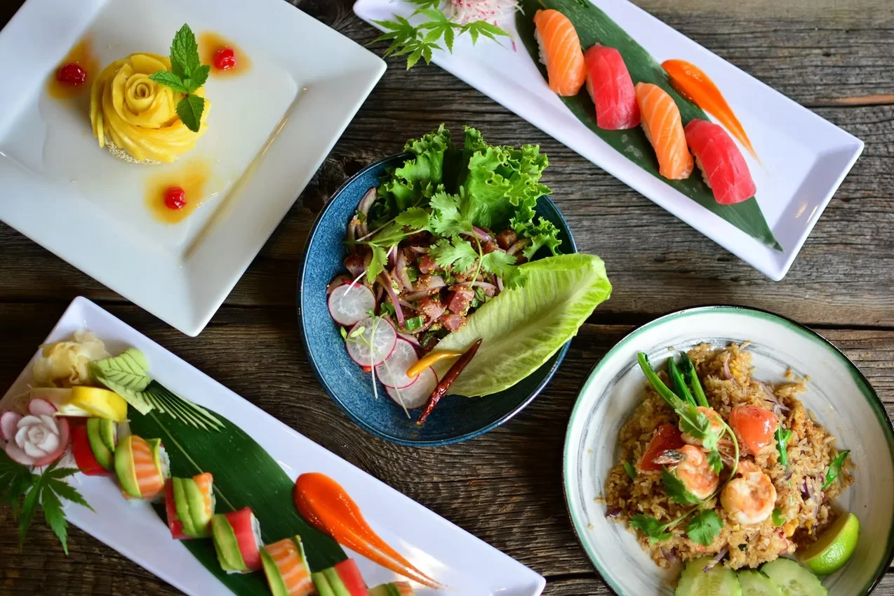 Assorted Japanese sushi platter with fresh sashimi and a dessert