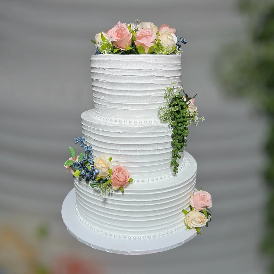 Elegant three-tier wedding cake with floral decorations