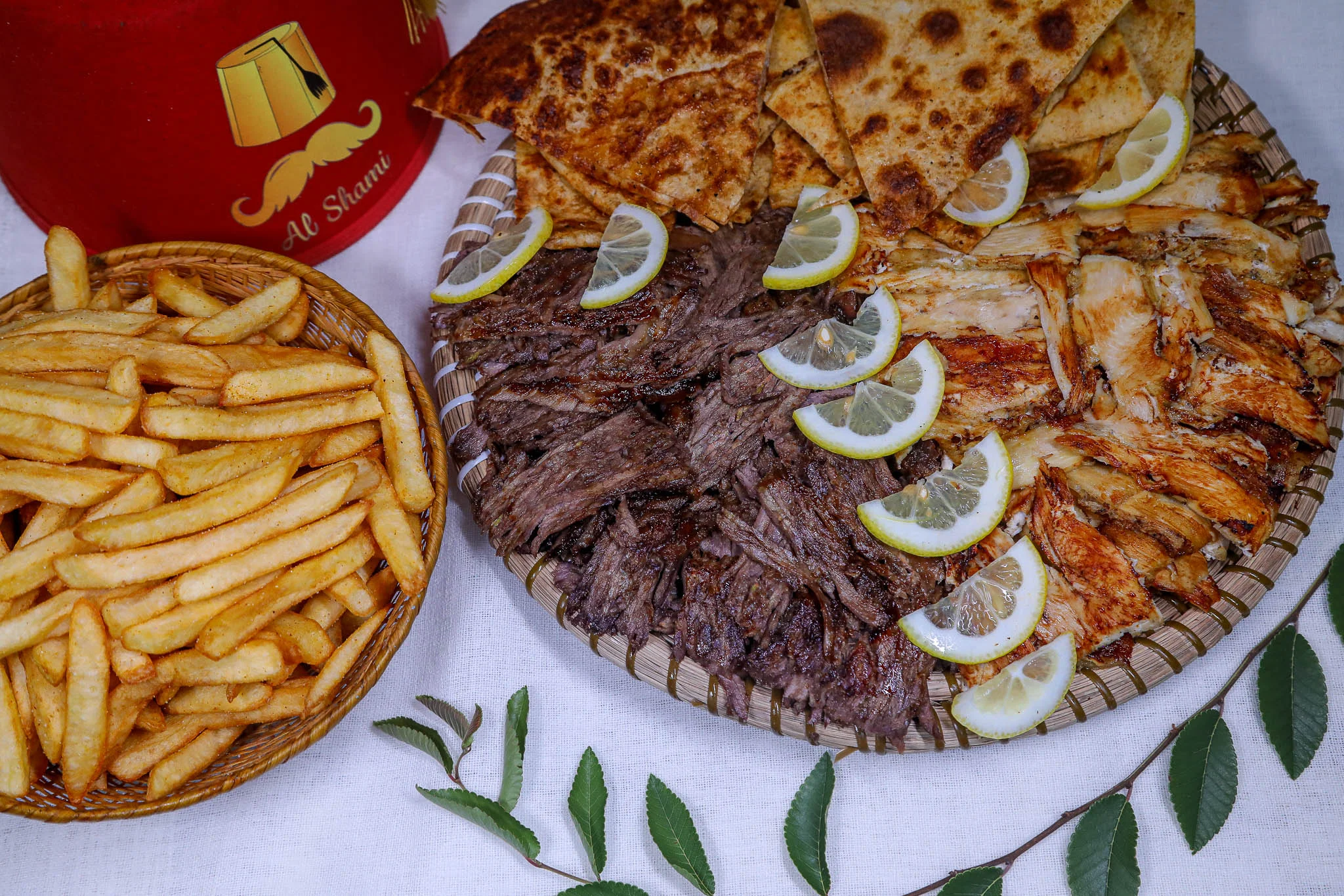 Middle Eastern mixed grill platter with pita and fries