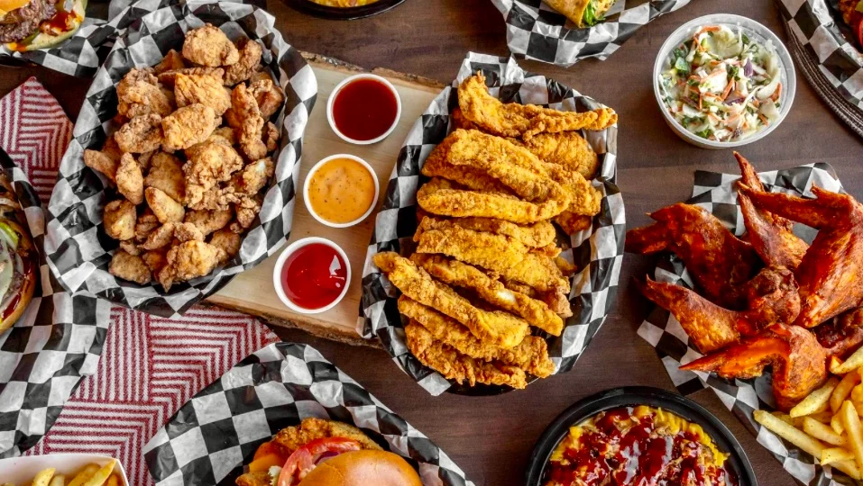 Southern fried chicken platter with sides and sauces
