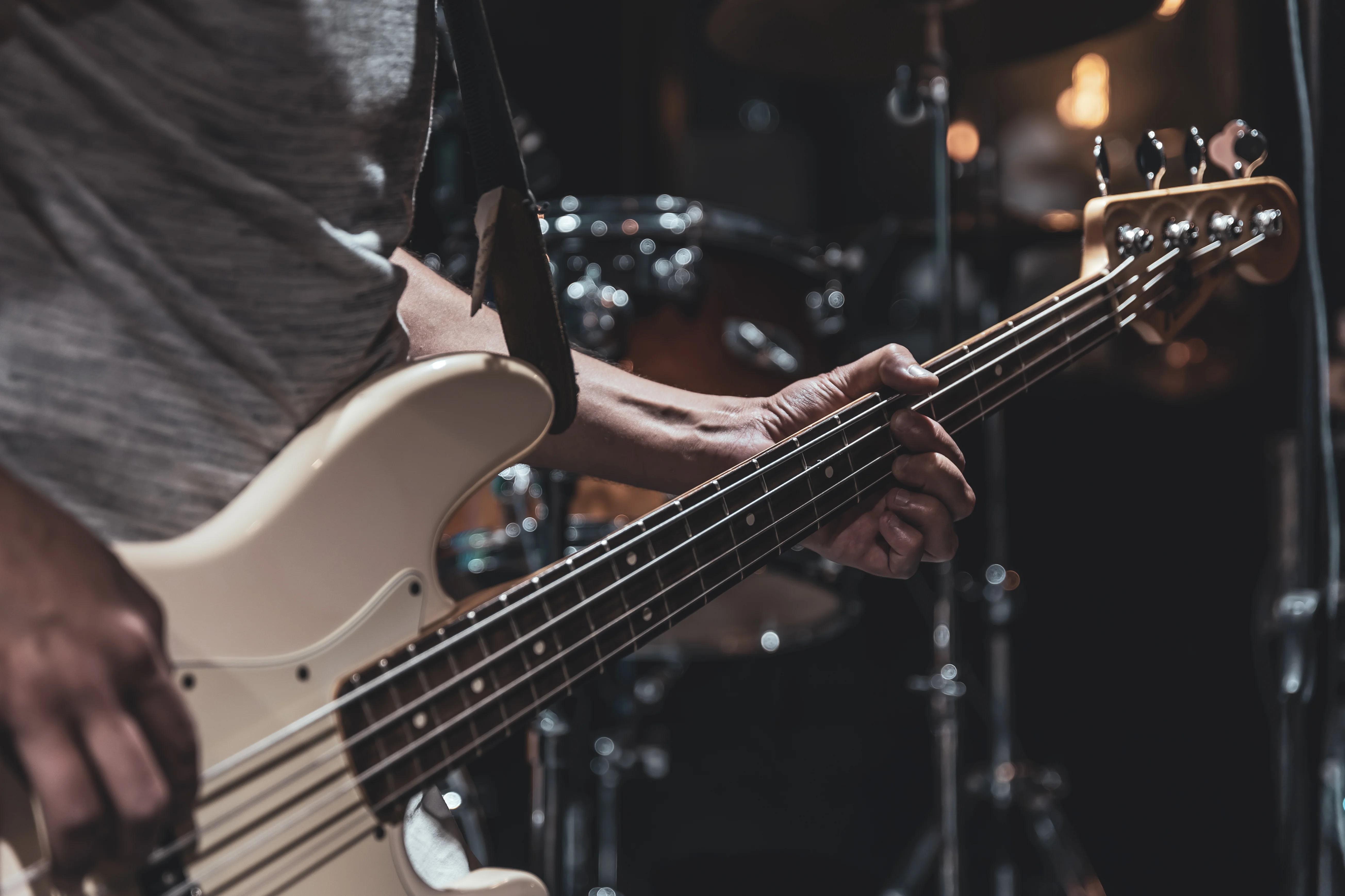 Musician playing bass guitar on stage