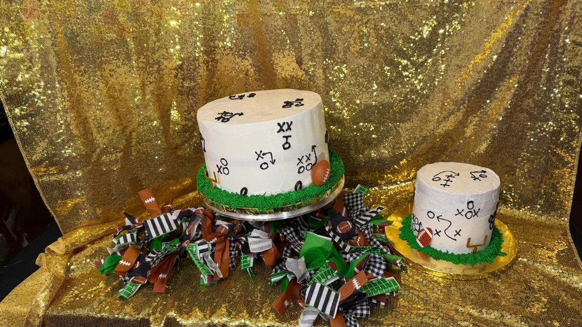 Football-themed cakes with playbook designs on a sparkling gold backdrop