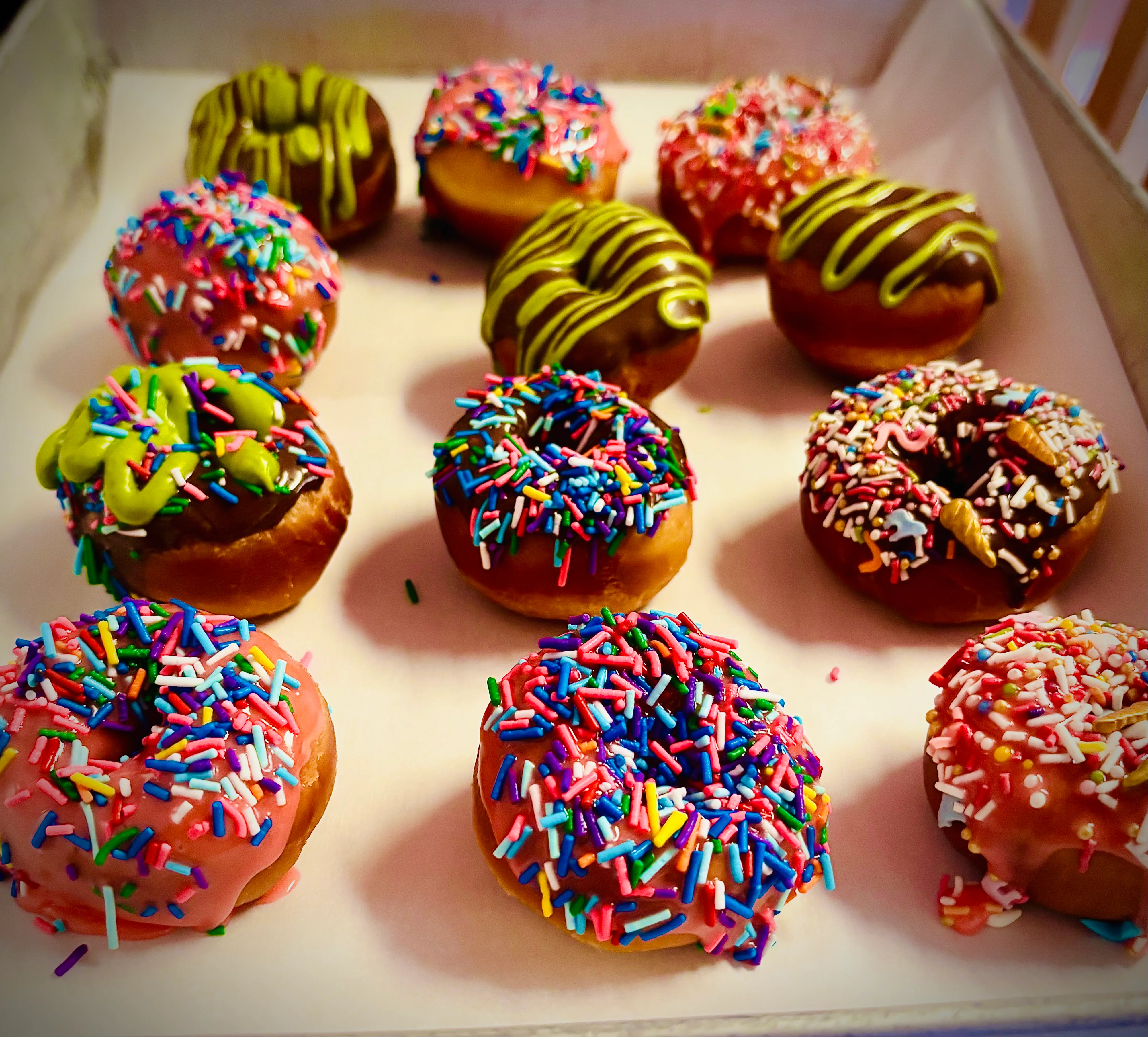 Colorful assortment of donuts with sprinkles and icing