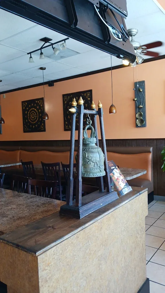Cozy restaurant interior featuring a decorative bell and warm lighting