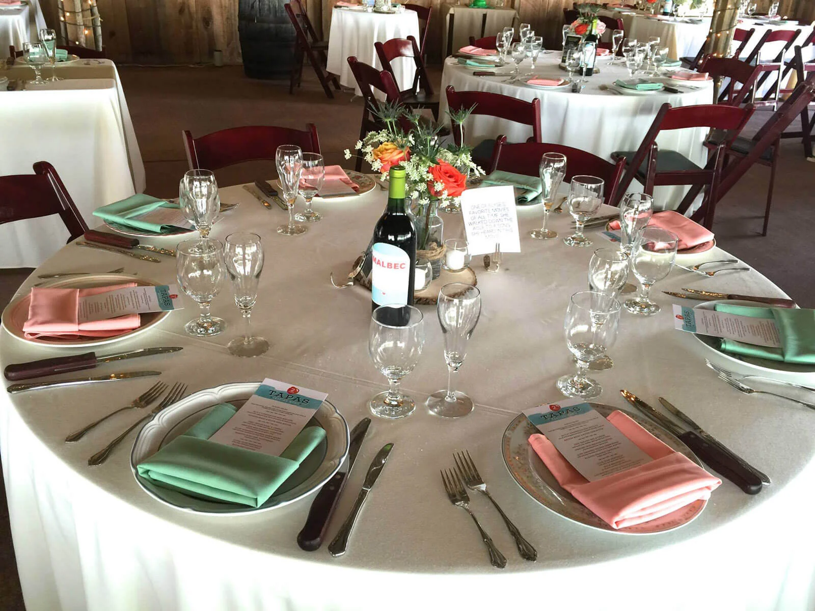 Elegant dining setup with colorful napkins and wine bottles