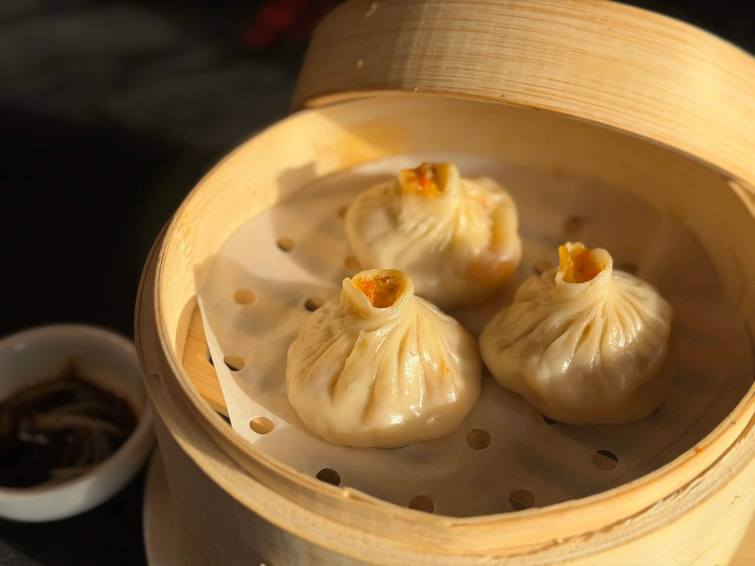 Steamed Chinese soup dumplings in a bamboo steamer