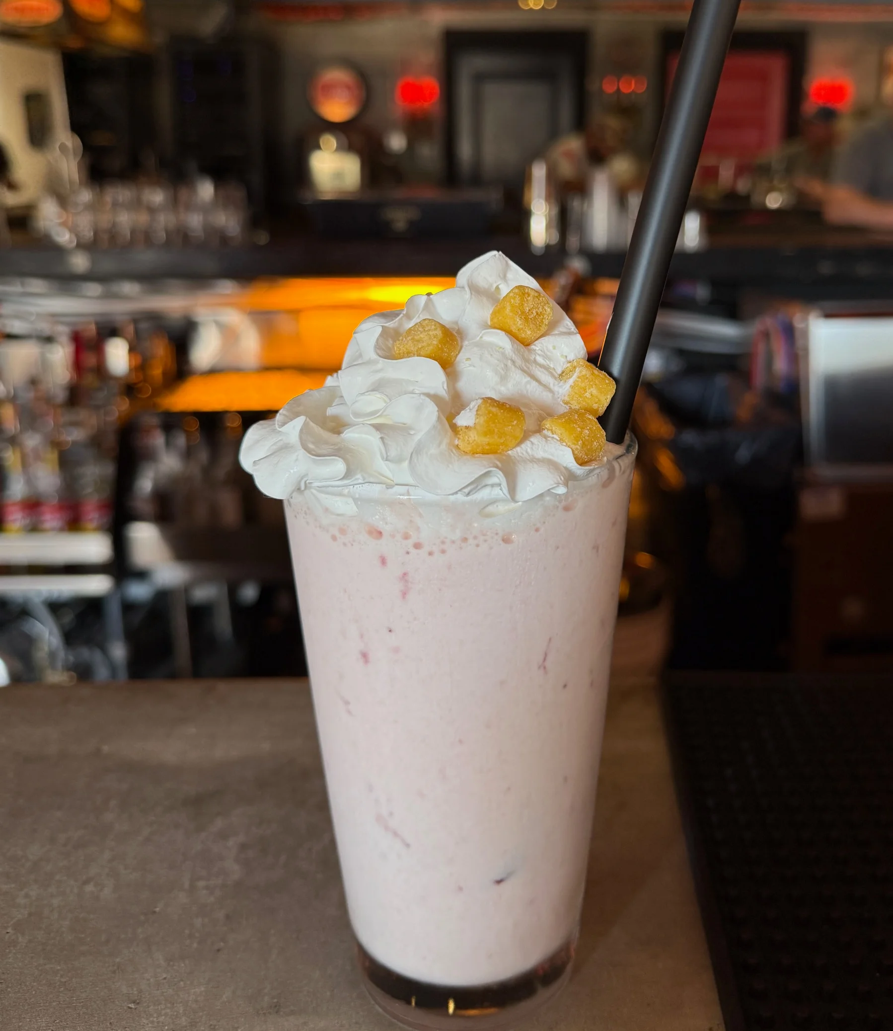 Fruity milkshake topped with whipped cream and candy