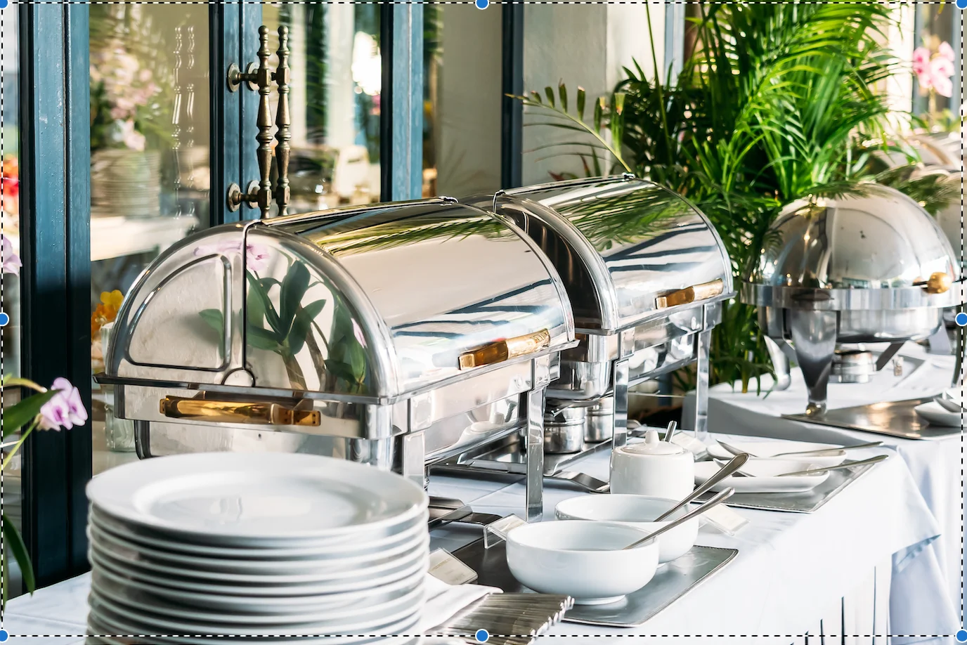 Elegant buffet setup with chafing dishes and fine dining tableware