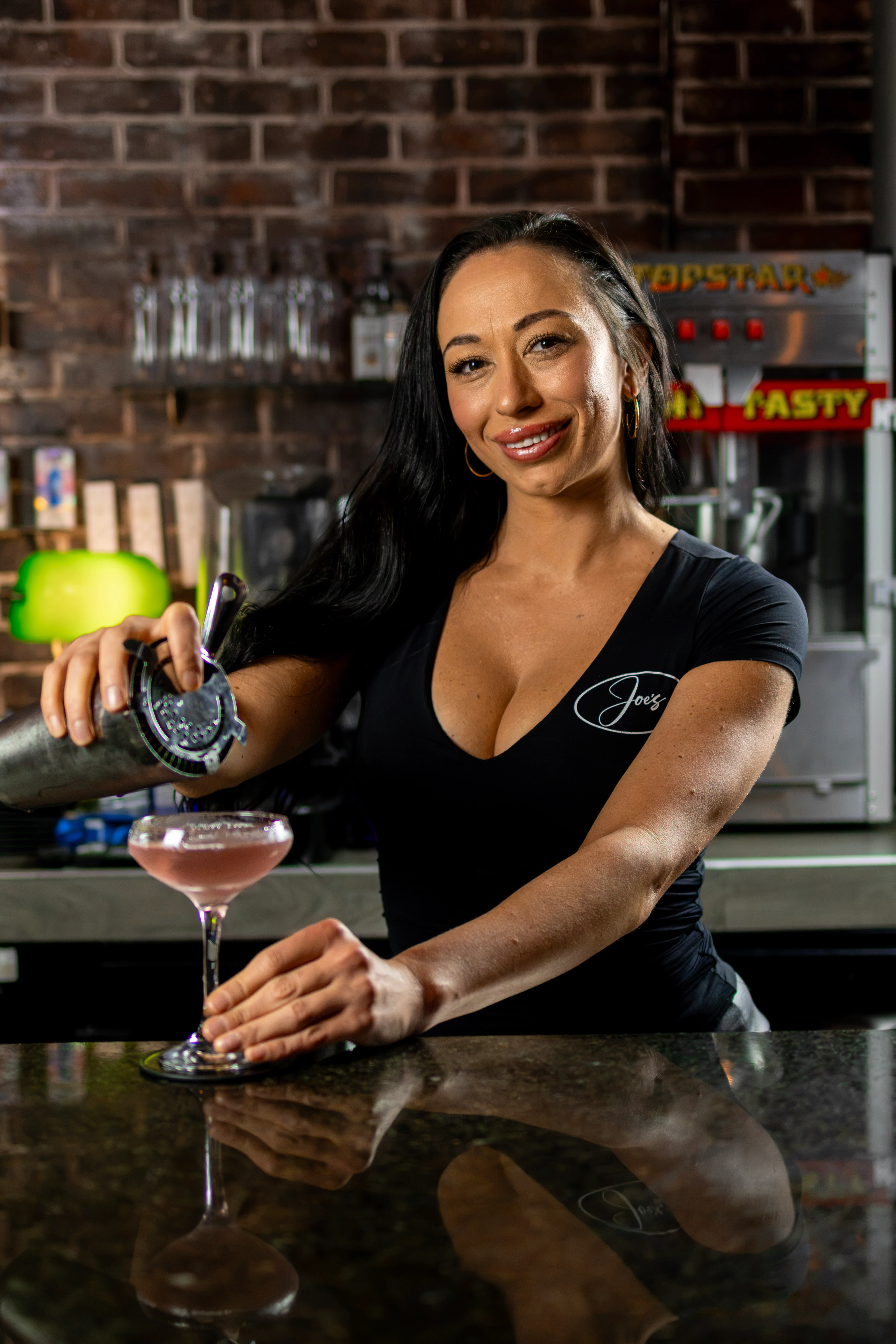 Bartender preparing a cocktail behind a restaurant bar