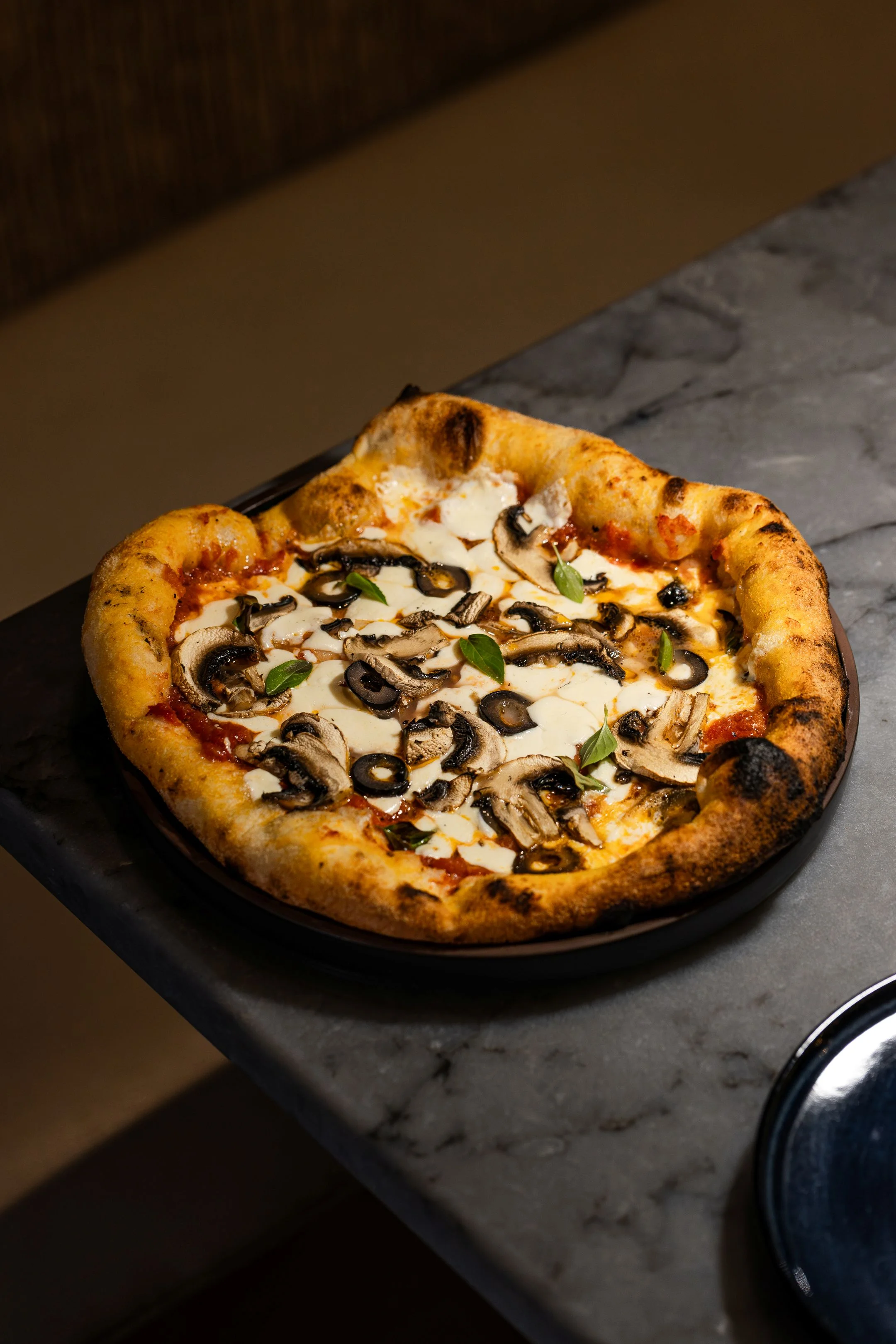 Wood-fired mushroom pizza with a crispy crust