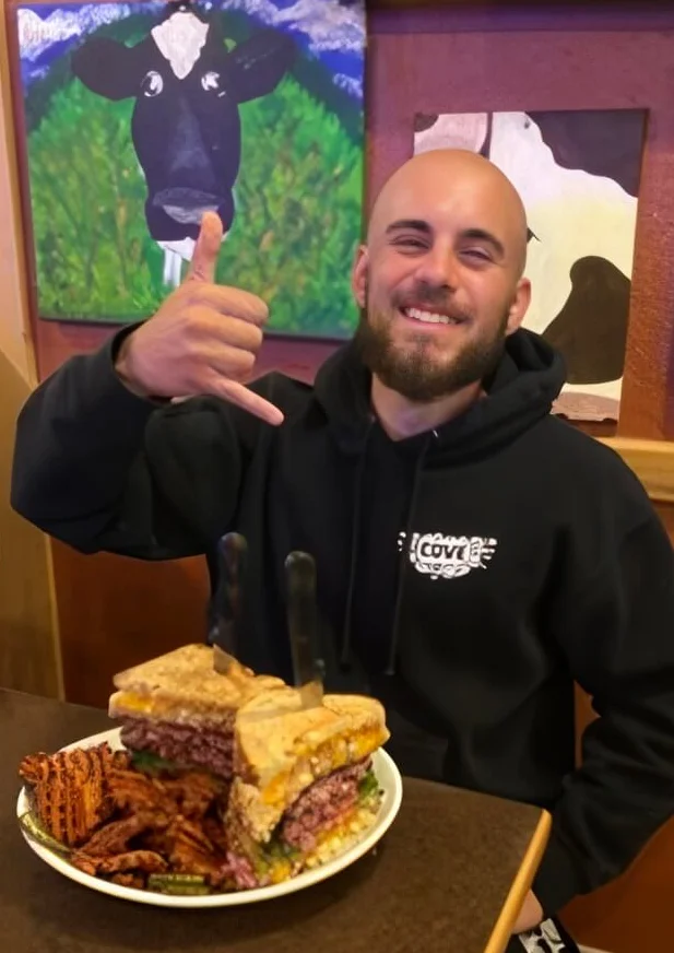 Giant deli sandwich with fries in a cozy restaurant