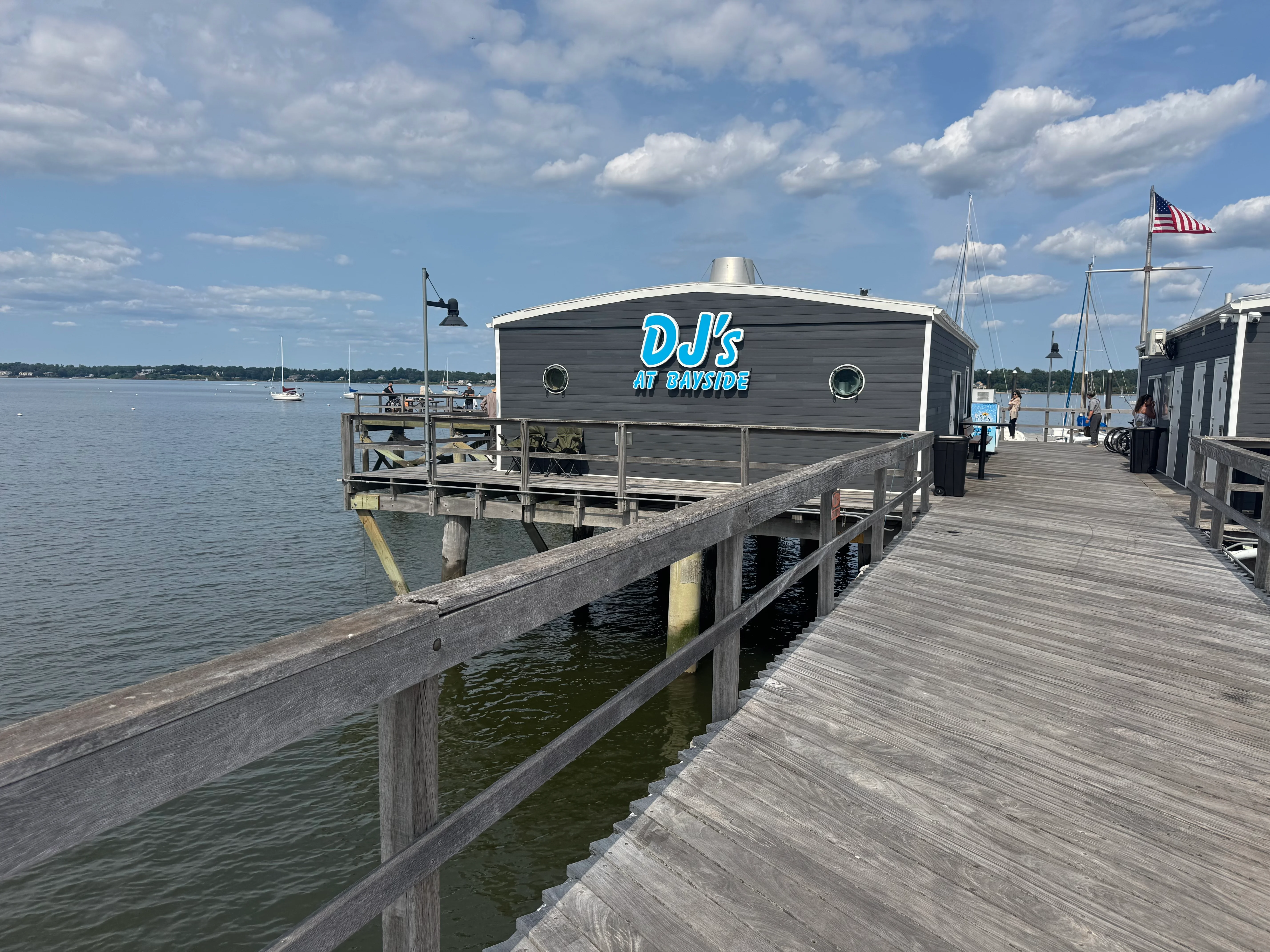 Waterfront restaurant DJ's at Bayside with boats in the background