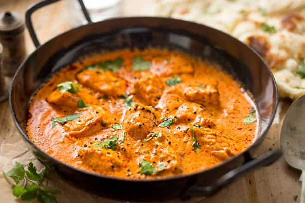 Creamy butter chicken curry served with naan bread
