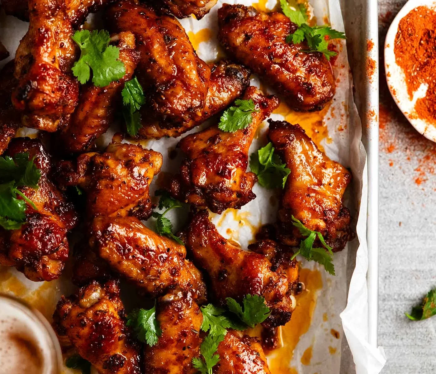 Crispy chicken wings with spicy glaze and fresh cilantro