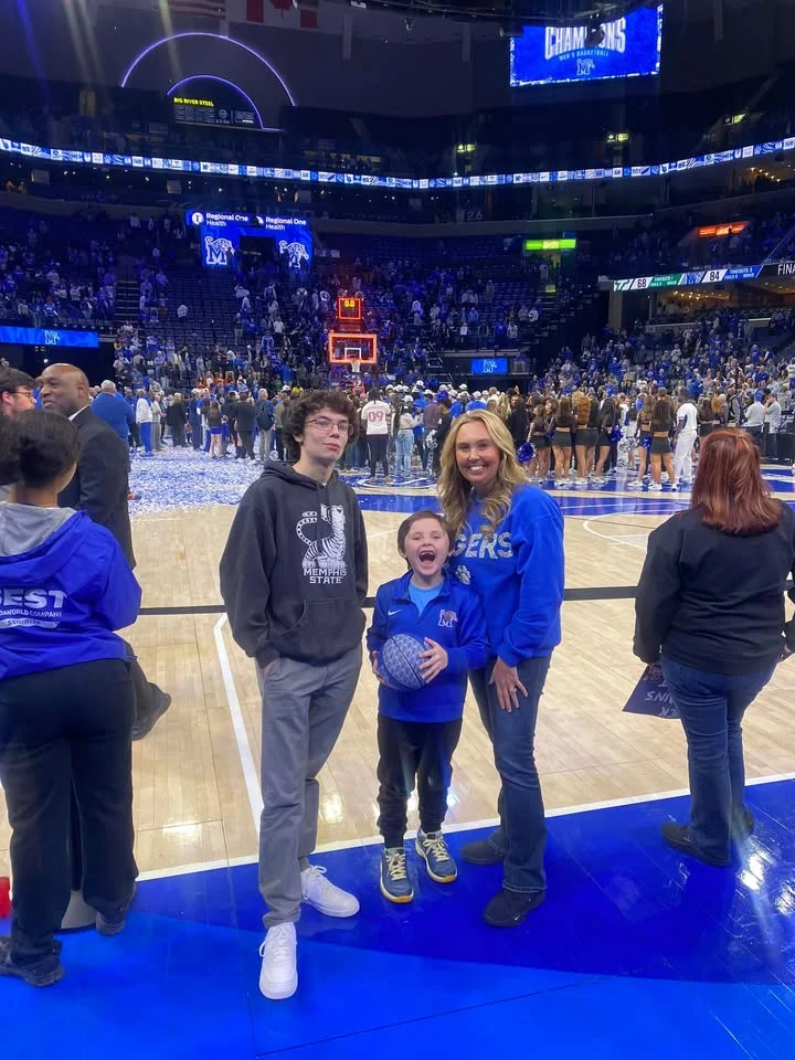 Family celebrating on the basketball court after a championship game
