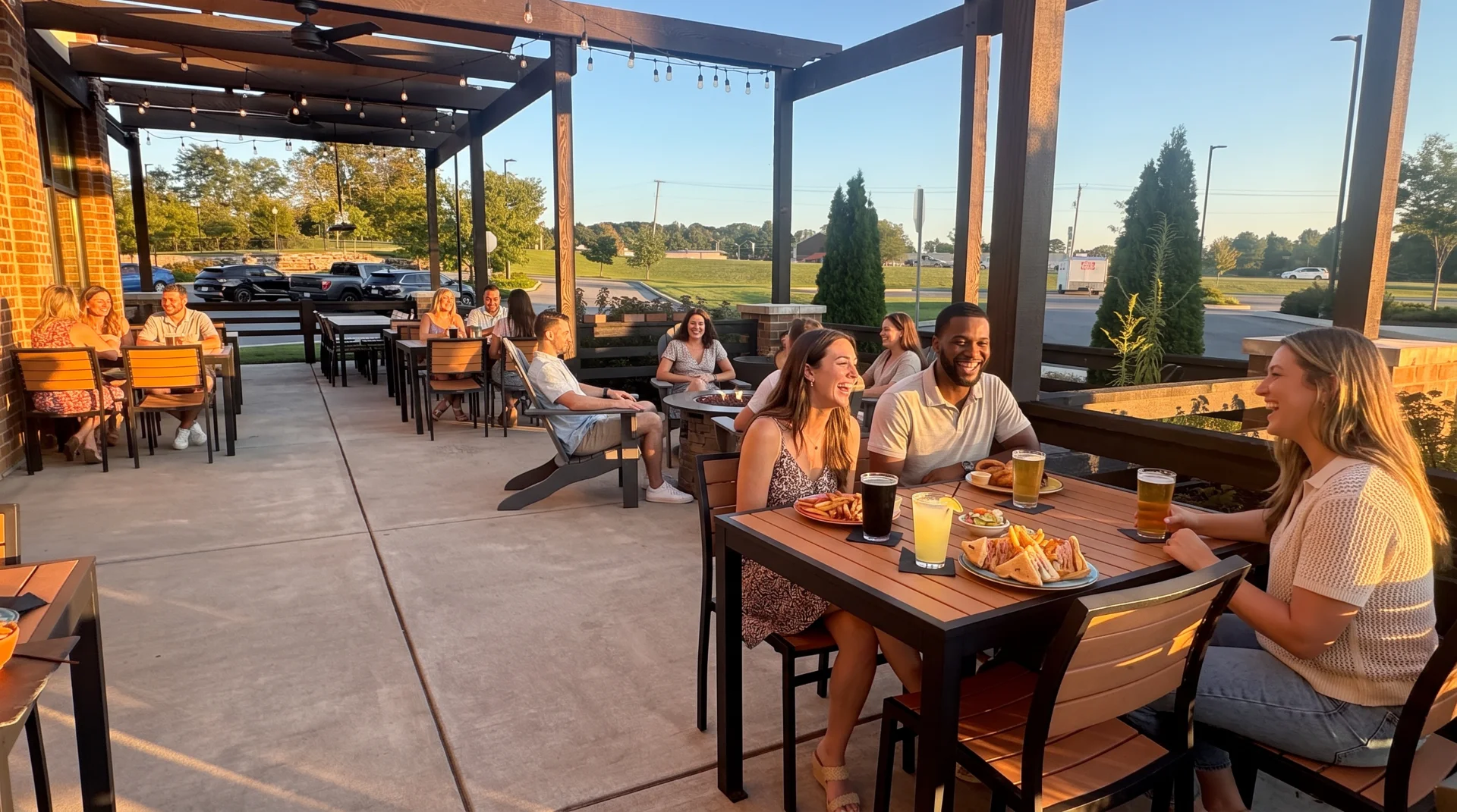 Outdoor dining area at night with string lights and guests enjoying the ambiance