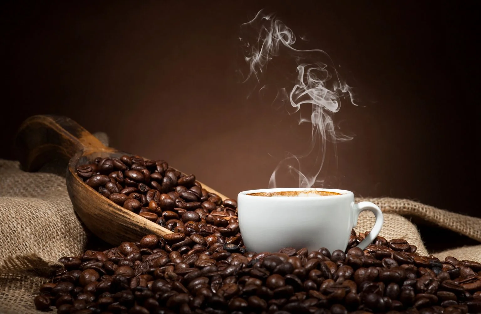 Freshly brewed coffee with steam rising from a white cup