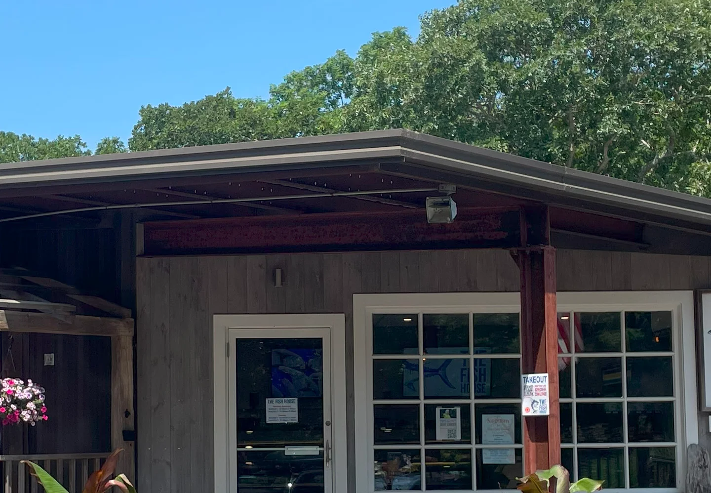 Exterior of The Fish House restaurant with takeout sign