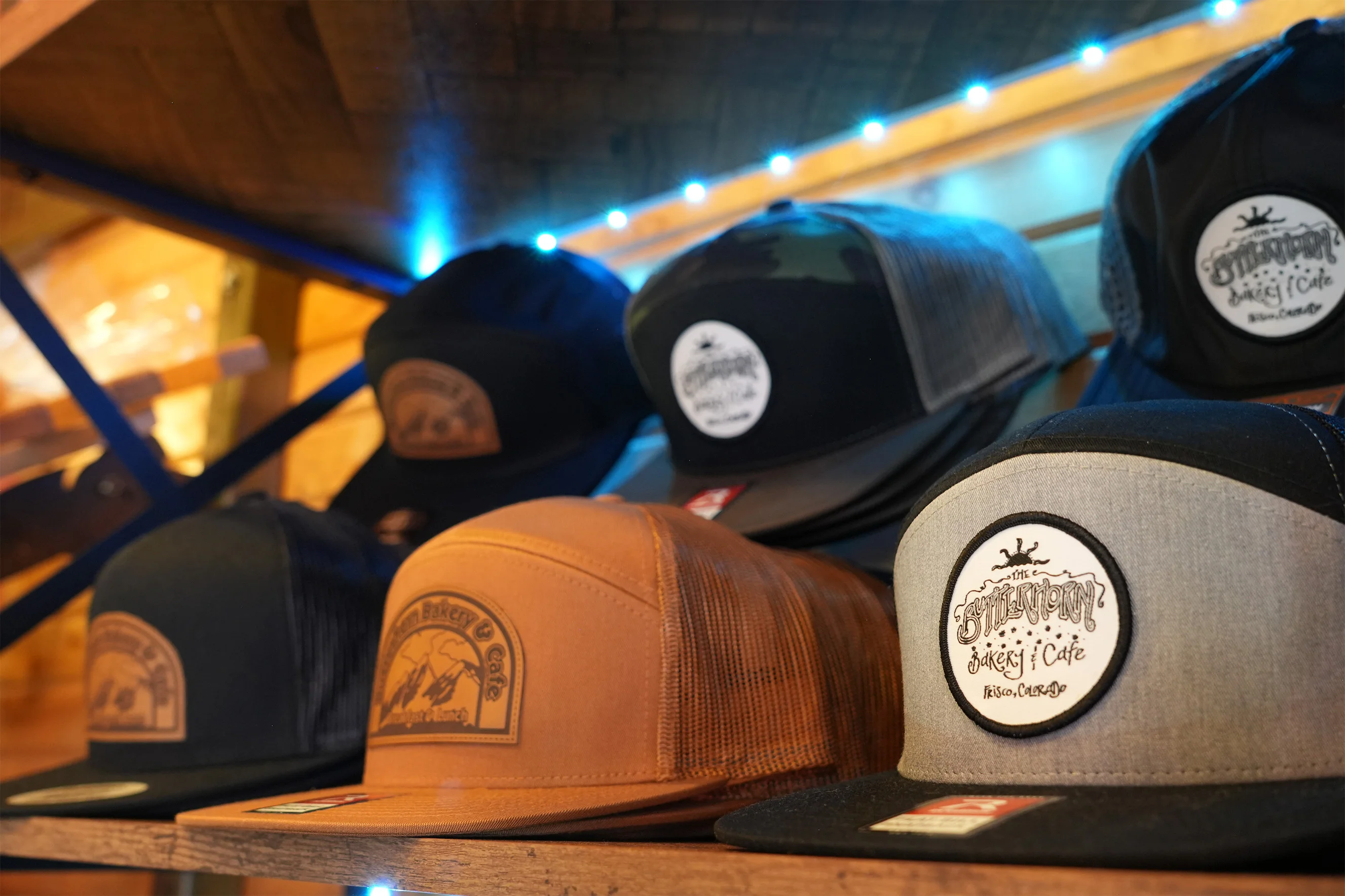 Branded trucker hats displayed in a warmly lit cafe