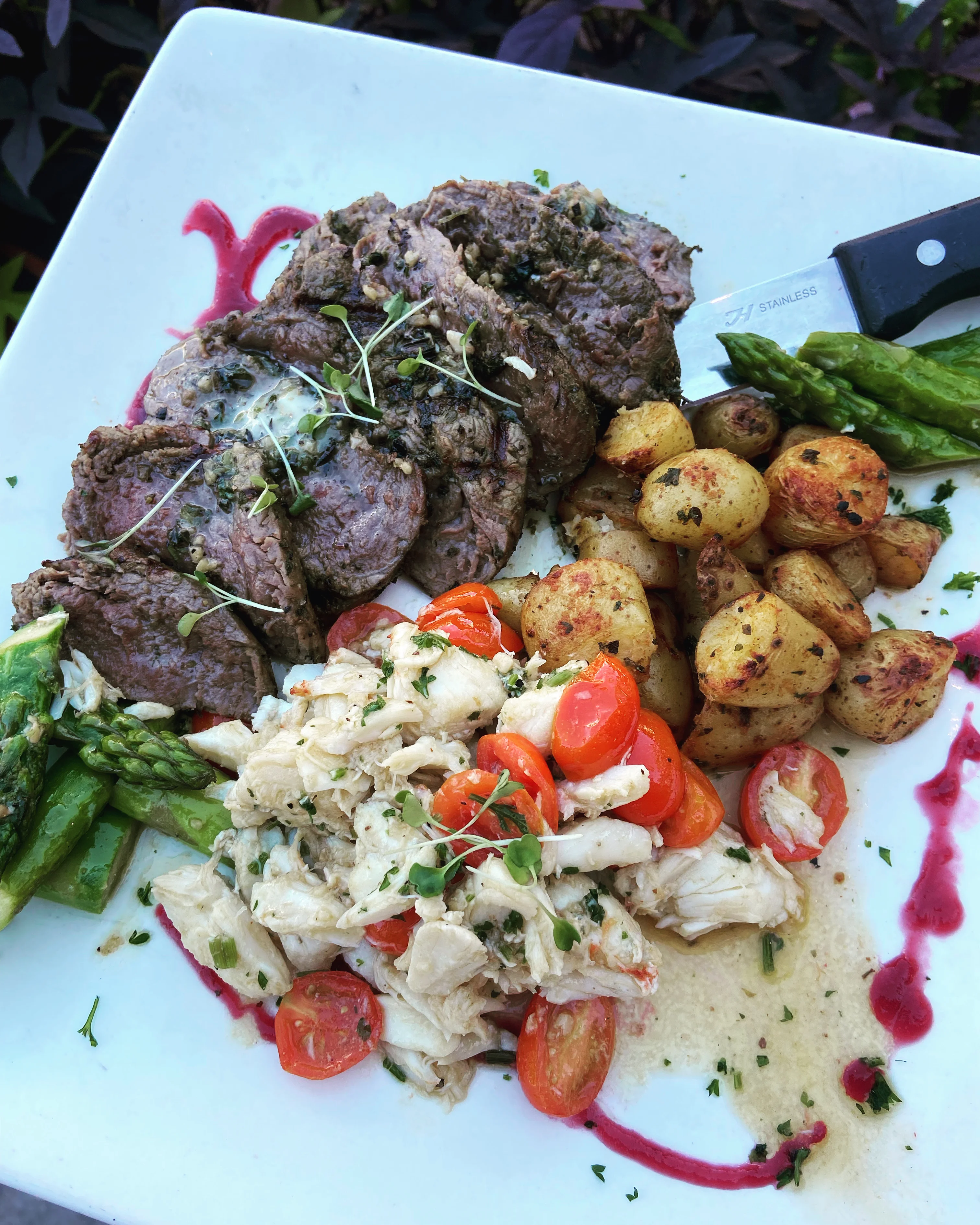 Grilled steak with crab and vegetables on a gourmet plate