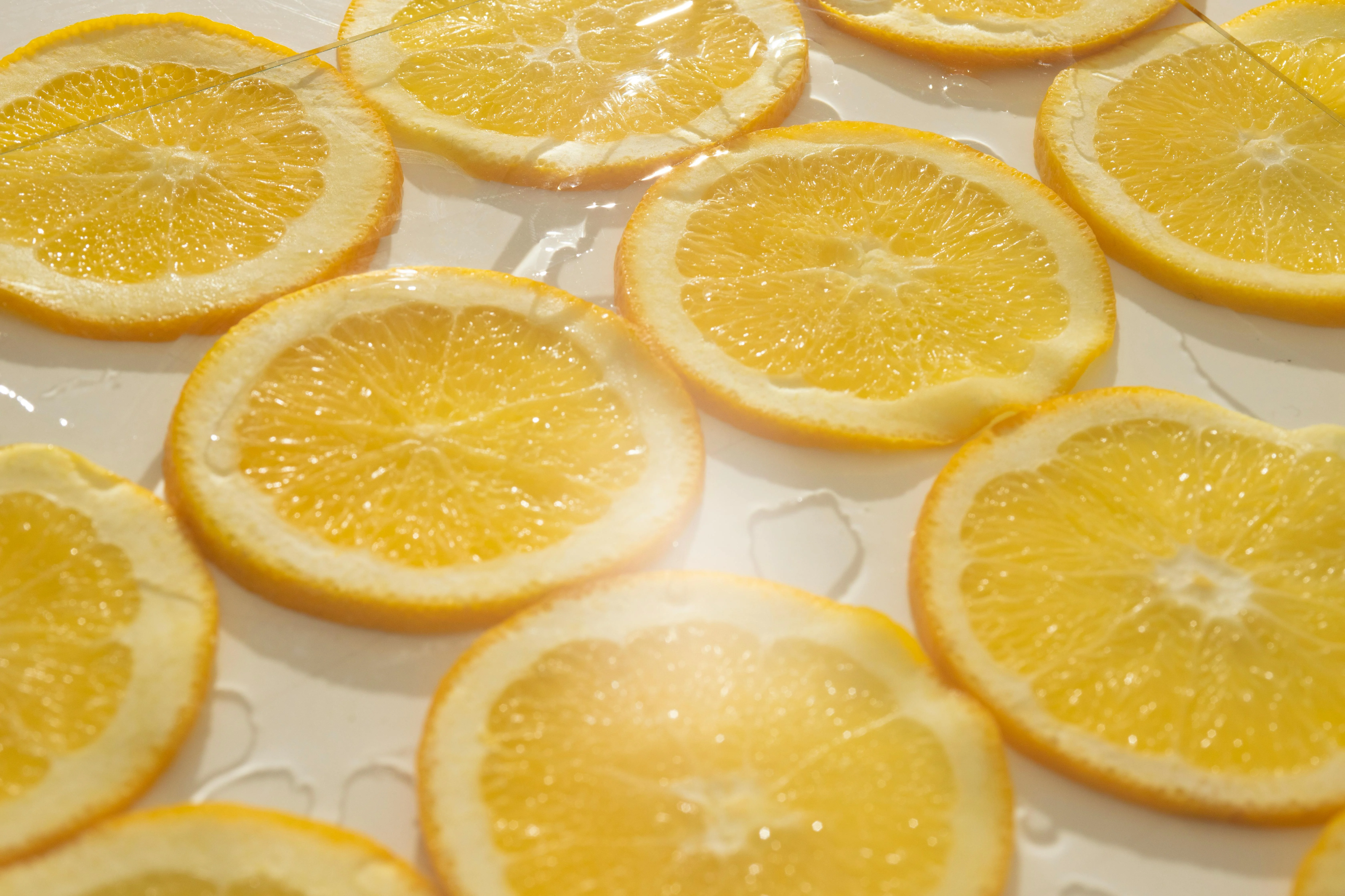 Sliced oranges arranged on a surface with water droplets