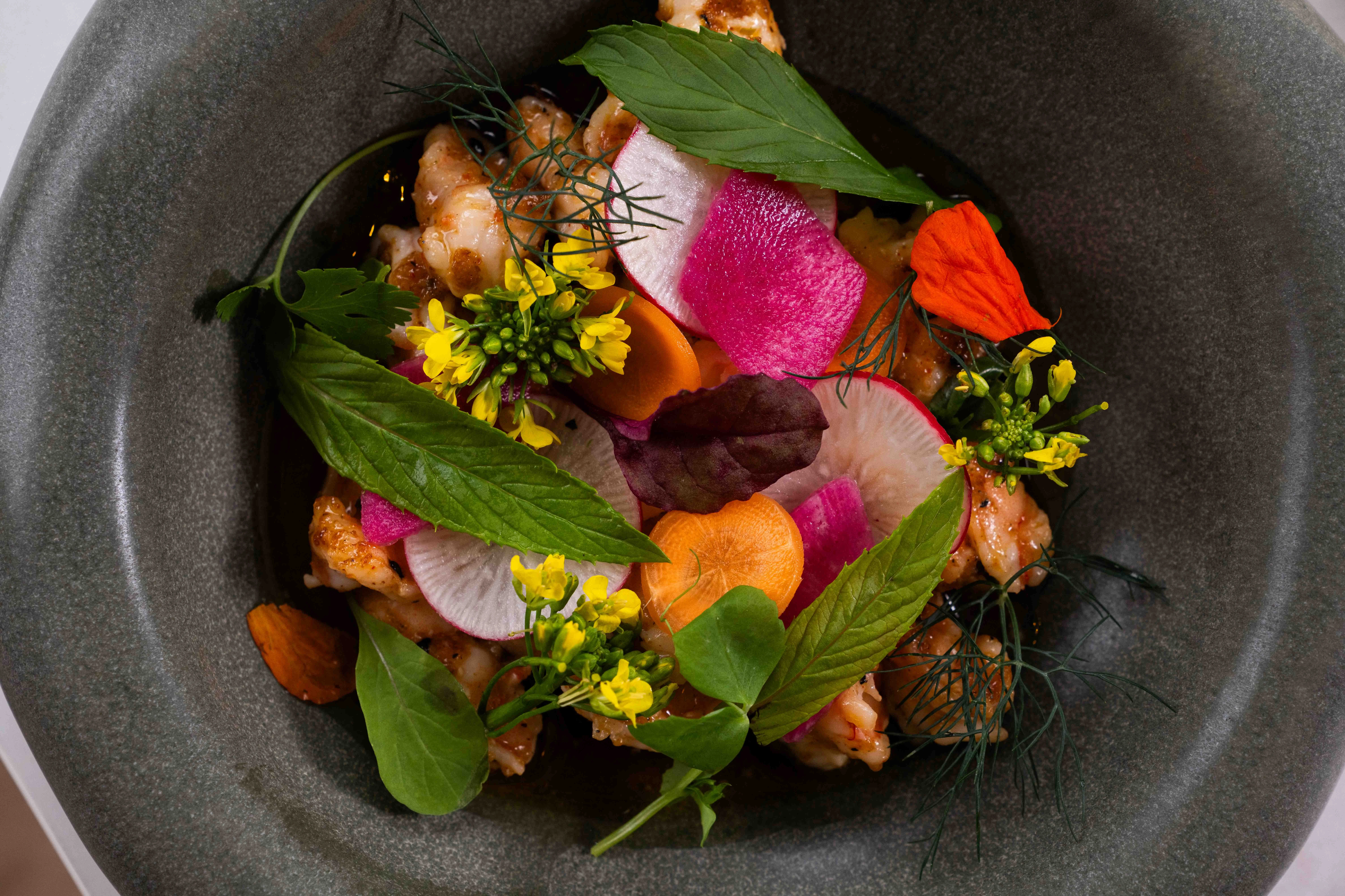 Artistic shrimp salad with edible flowers