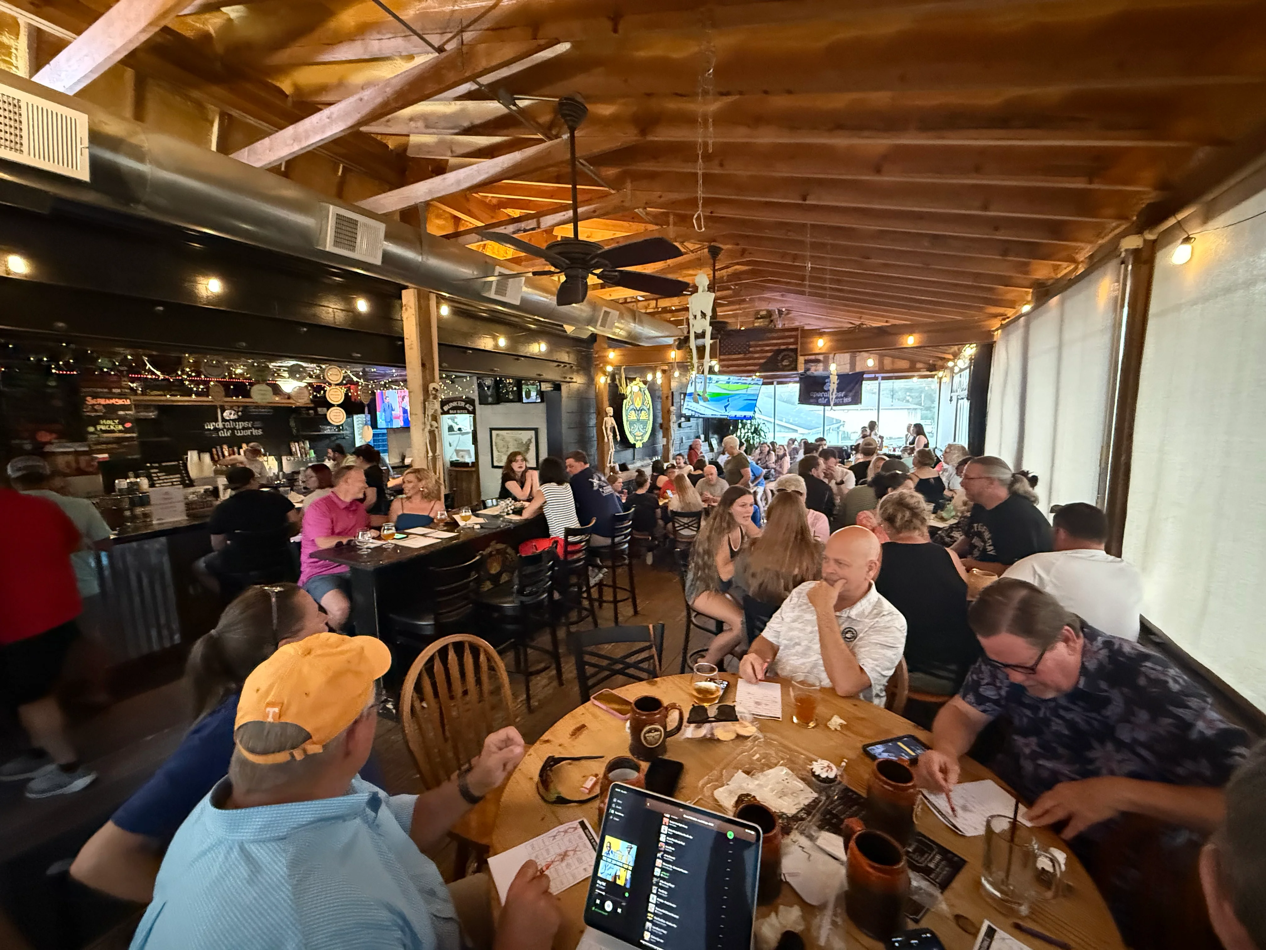 Lively restaurant interior with patrons enjoying food and drinks