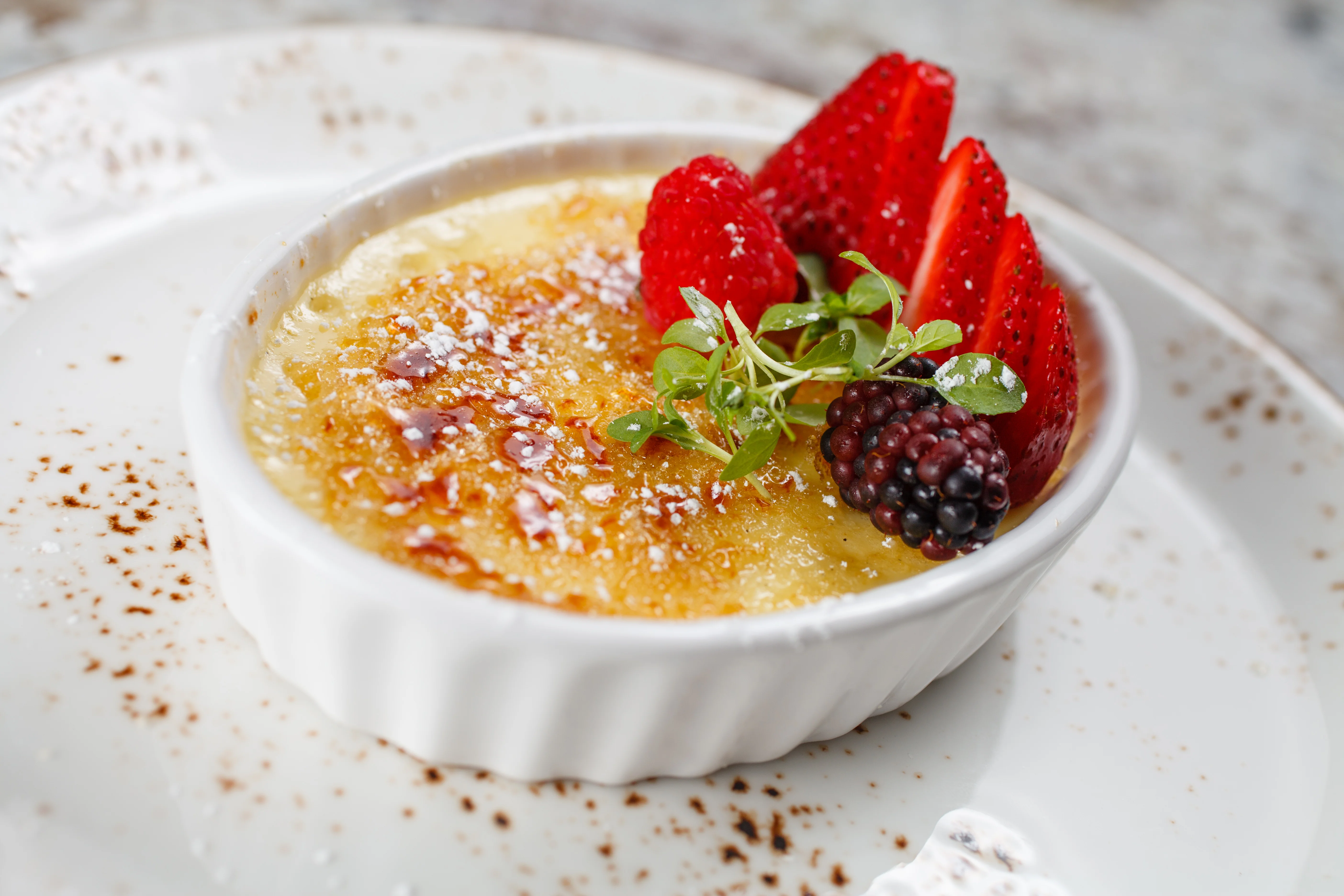 Classic French crème brûlée with fresh berries