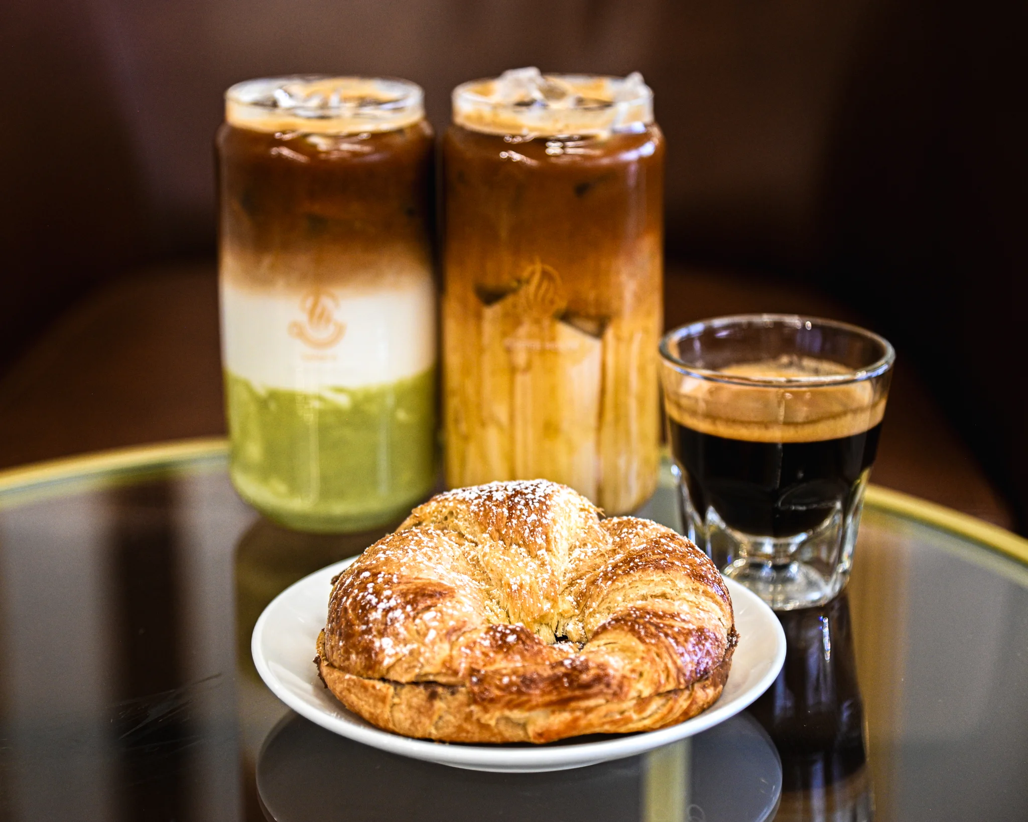 Freshly baked croissant with espresso and iced coffee drinks