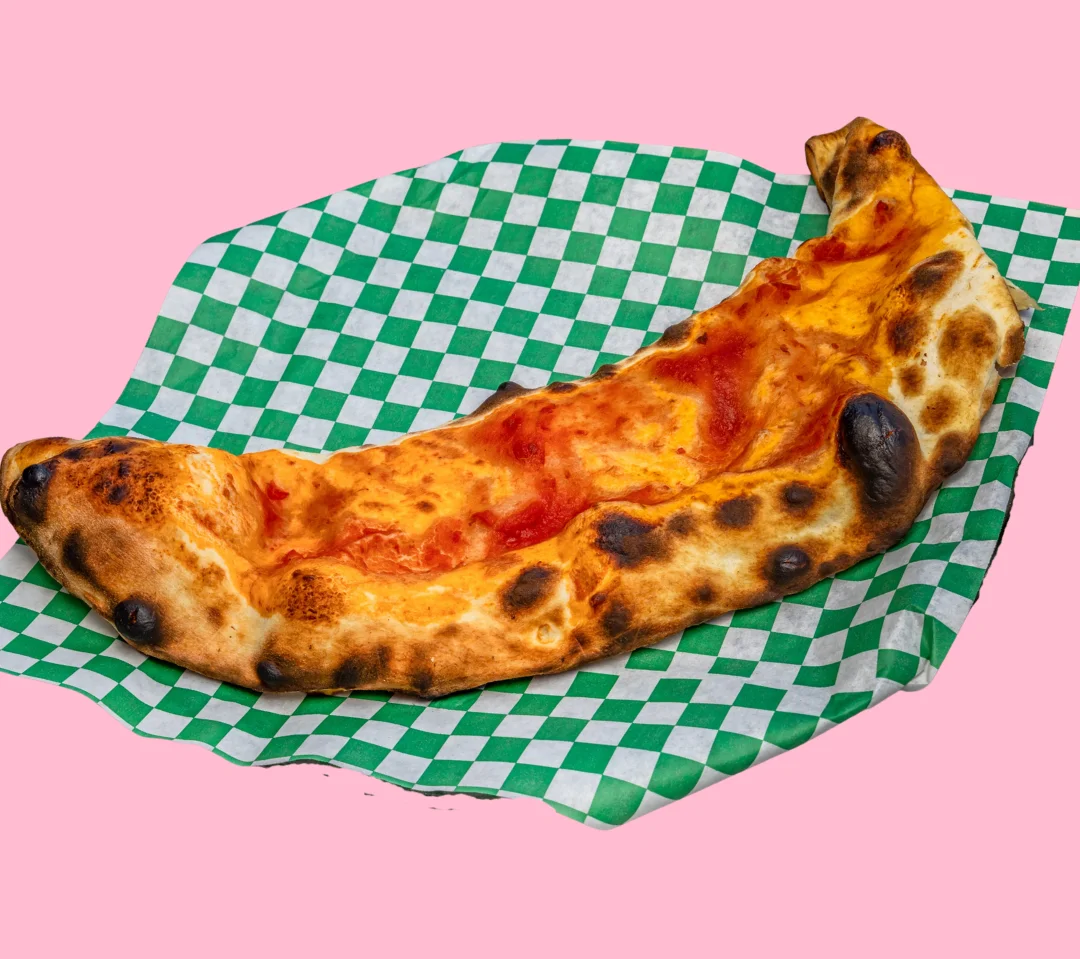 Neapolitan-style pizza on green checkered paper