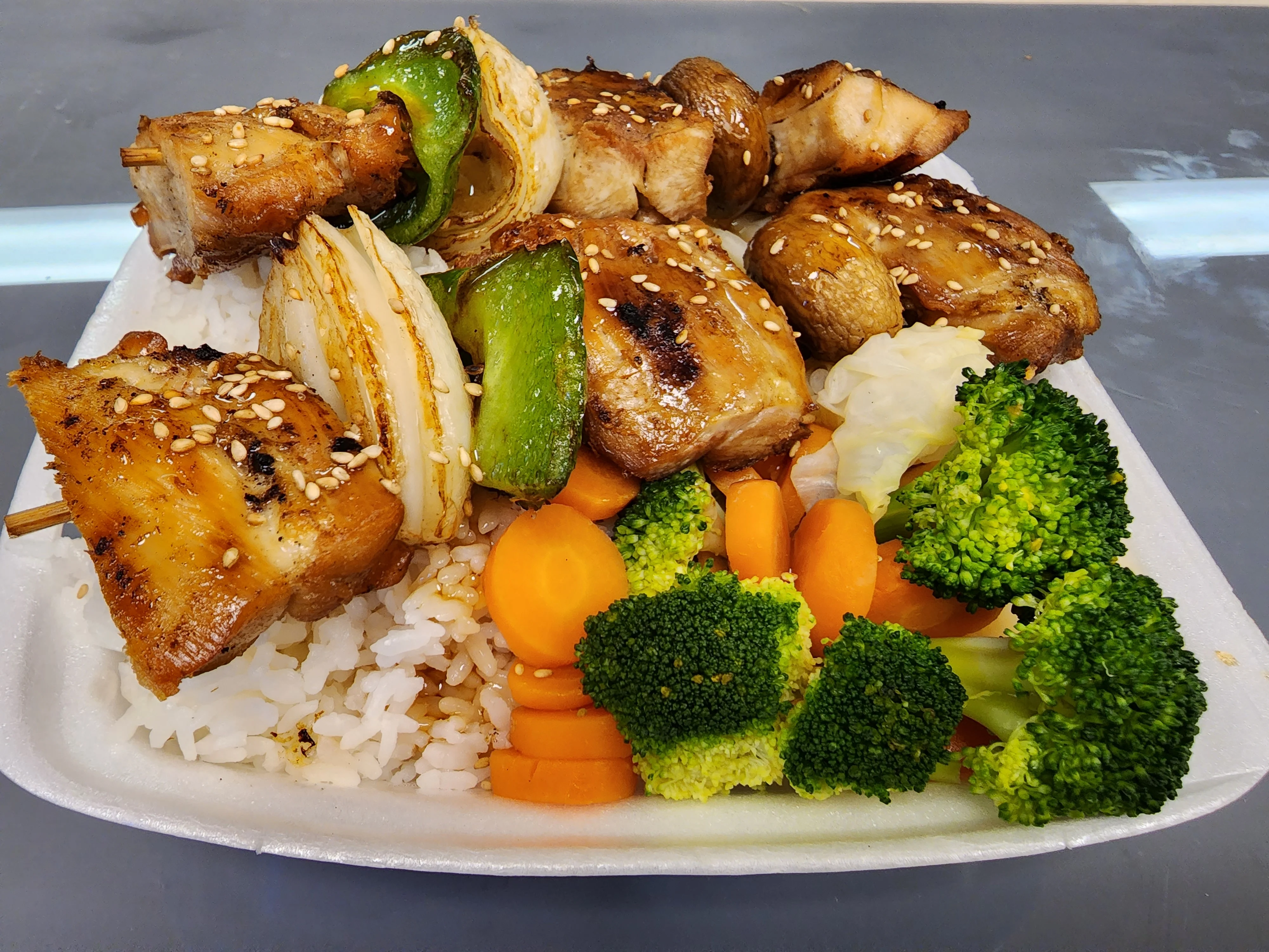 Grilled chicken teriyaki rice bowl with vegetables