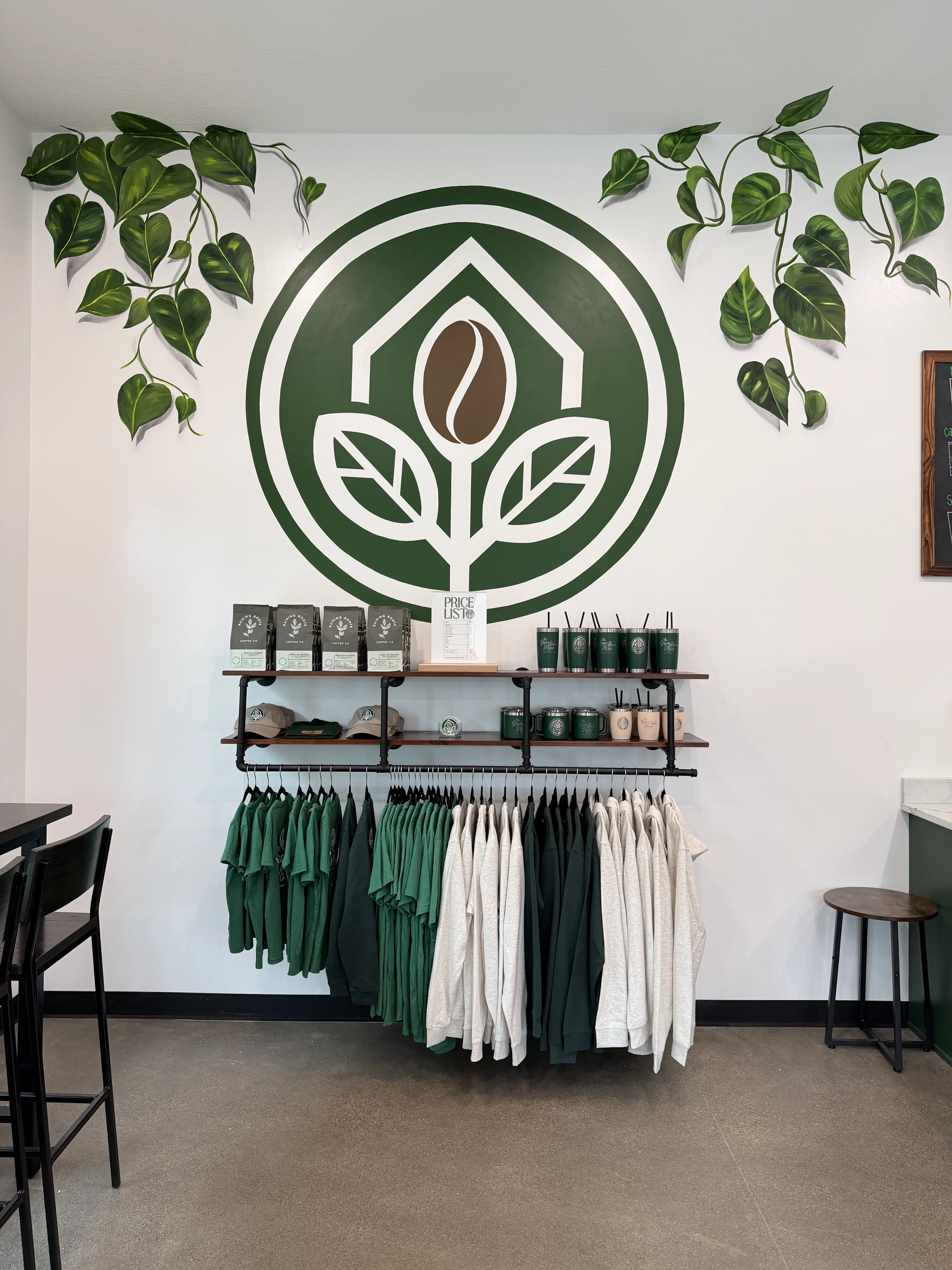 Stylish café interior with green decor and merchandise display