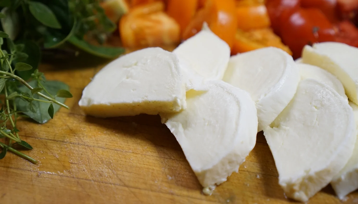 Fresh mozzarella and tomatoes for Caprese salad preparation