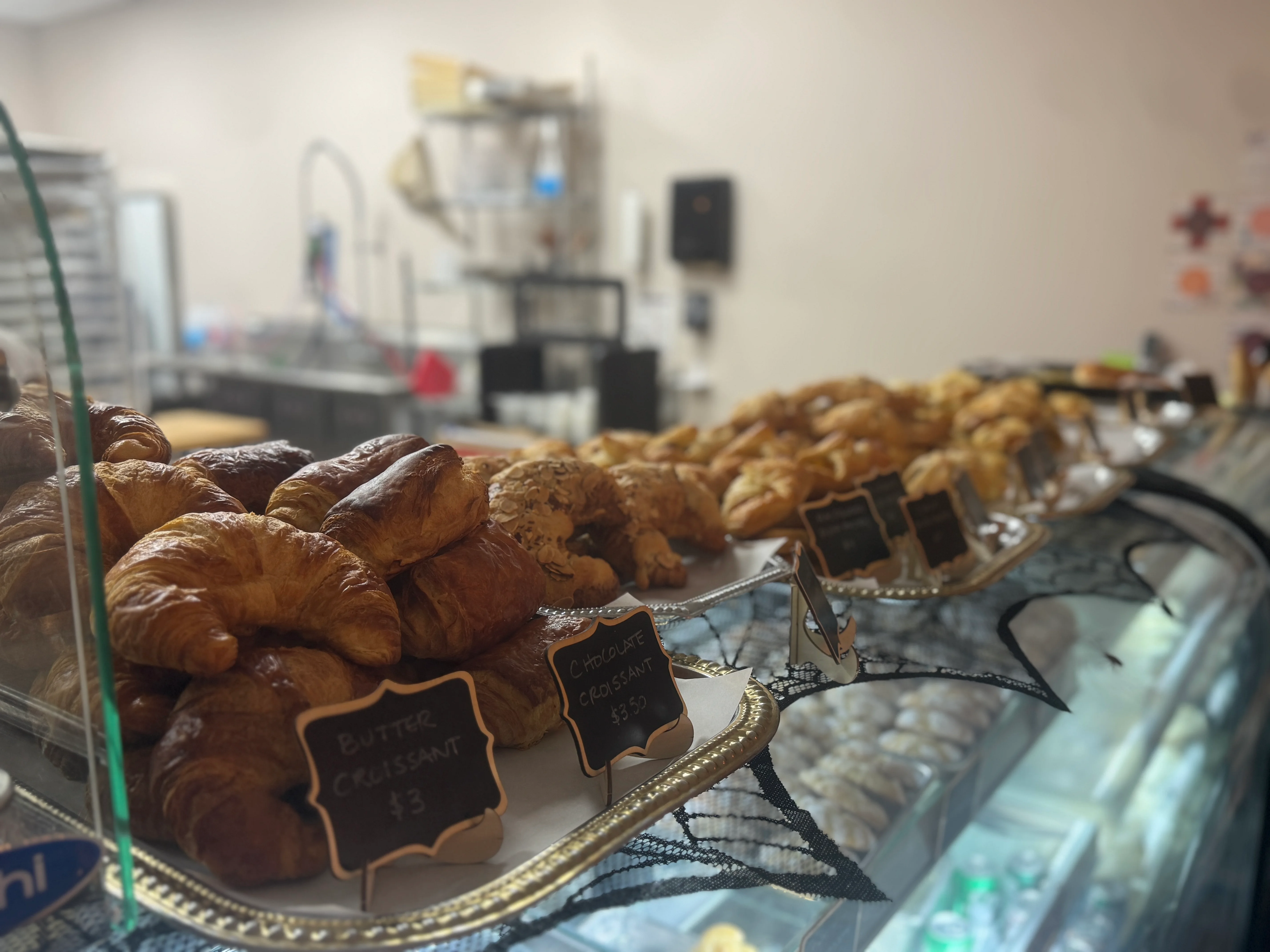 Freshly baked butter and chocolate croissants in a bakery display