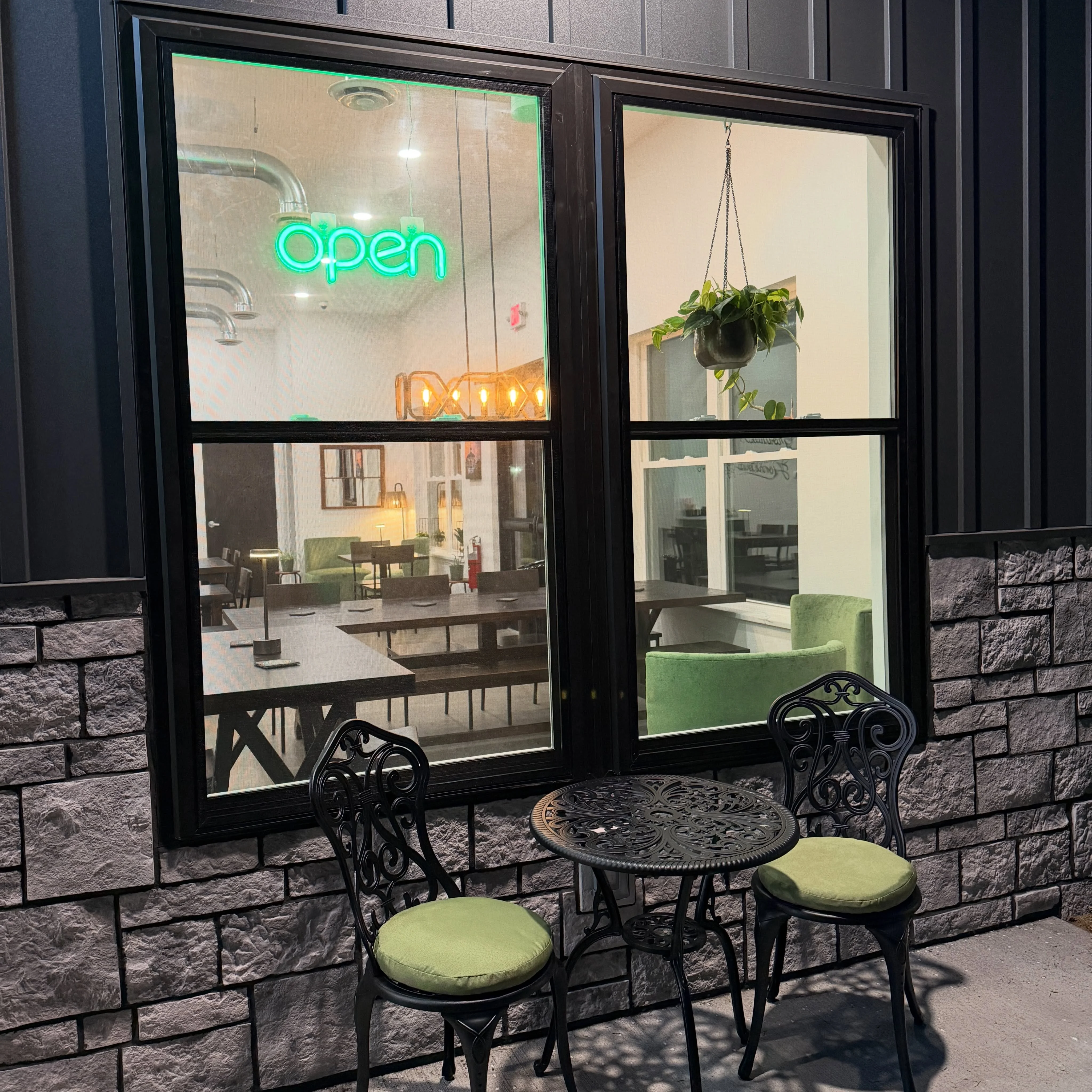 Cozy restaurant exterior with open sign and outdoor seating