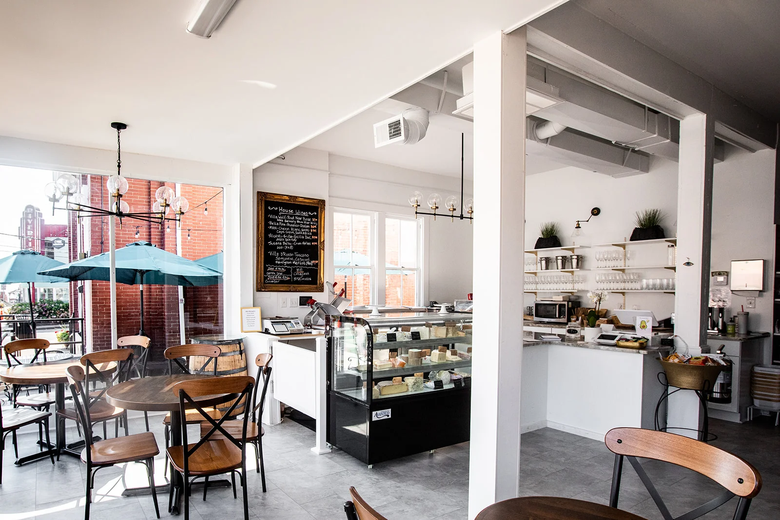 Cozy café interior with wooden tables and a glass display case