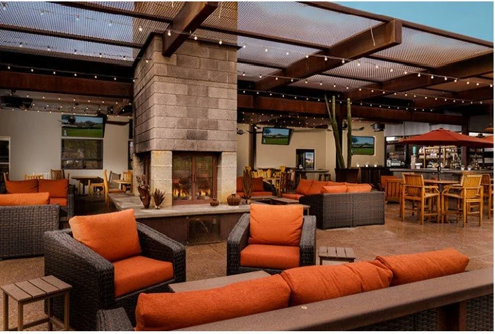 Stylish outdoor restaurant seating with cozy fireplace