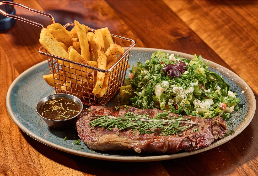 Grilled ribeye served with house Mediterranean sauce.