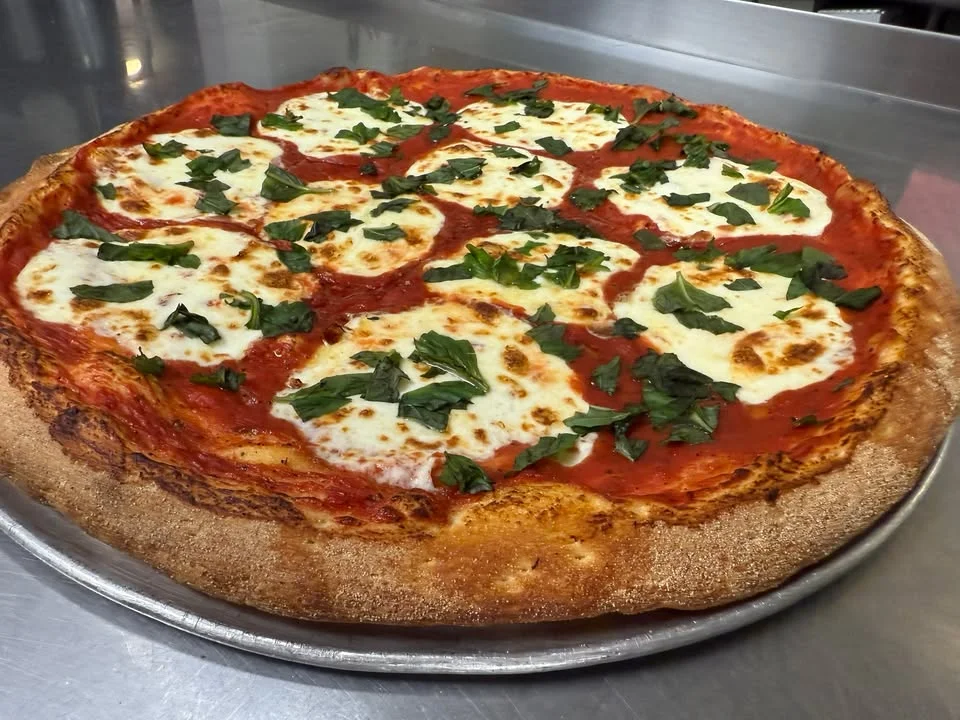 Margherita pizza with fresh basil and mozzarella