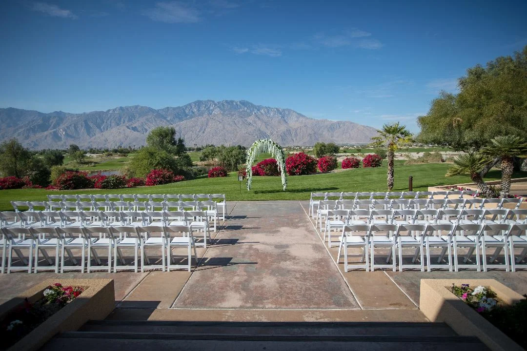 Outdoor wedding ceremony setup with mountain backdrop