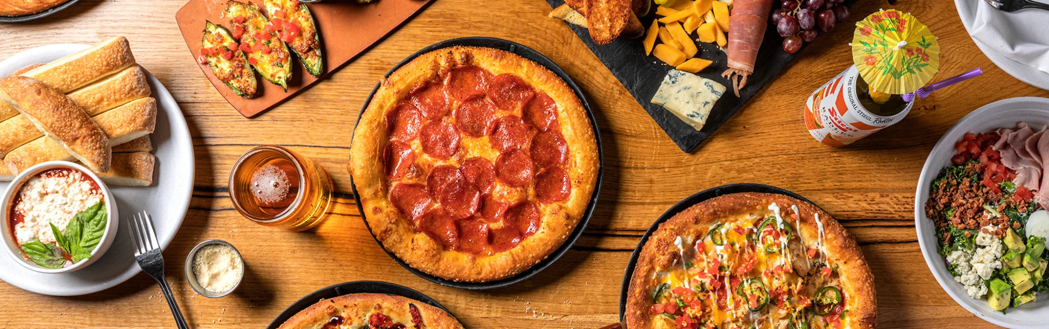Delicious pepperoni pizza served with garlic bread and fresh salad