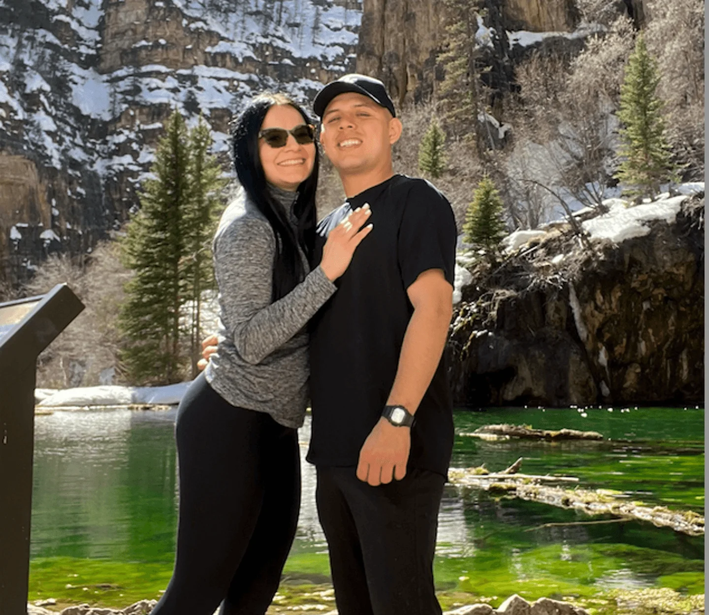Couple posing by a scenic mountain lake in spring