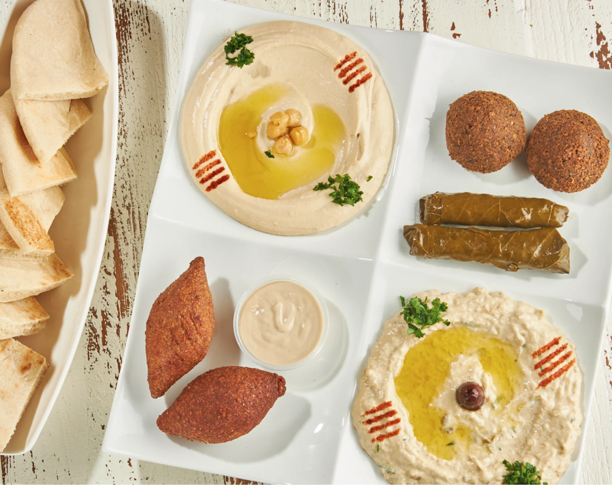 Sufrat Sampler: 2 Kibbeh, 2 falafel, 2 grape Leaves, Hummus Baba Ghanouge, and fresh pita Bread
