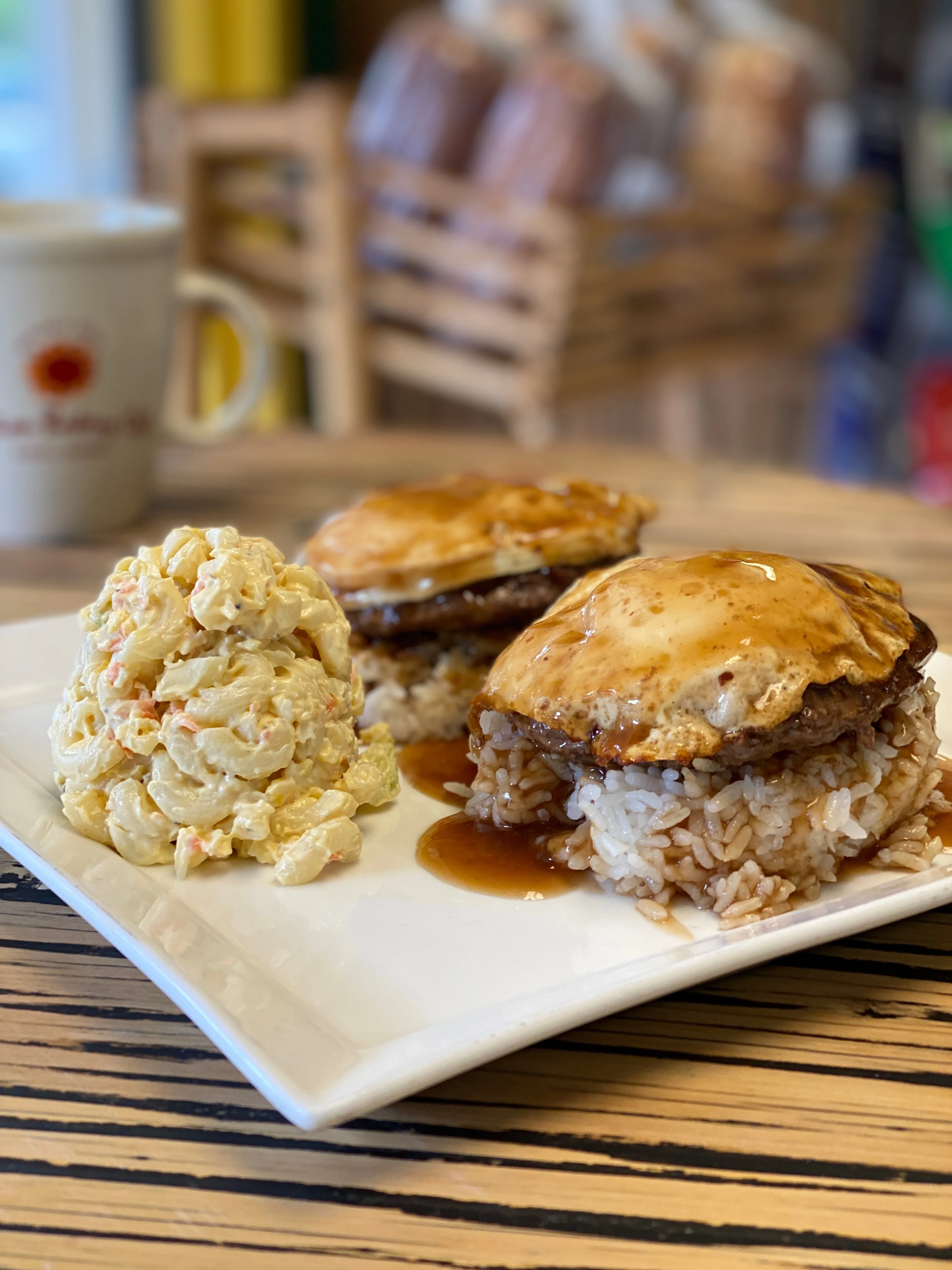 A passion bakery specialty burger with a side of macaroni