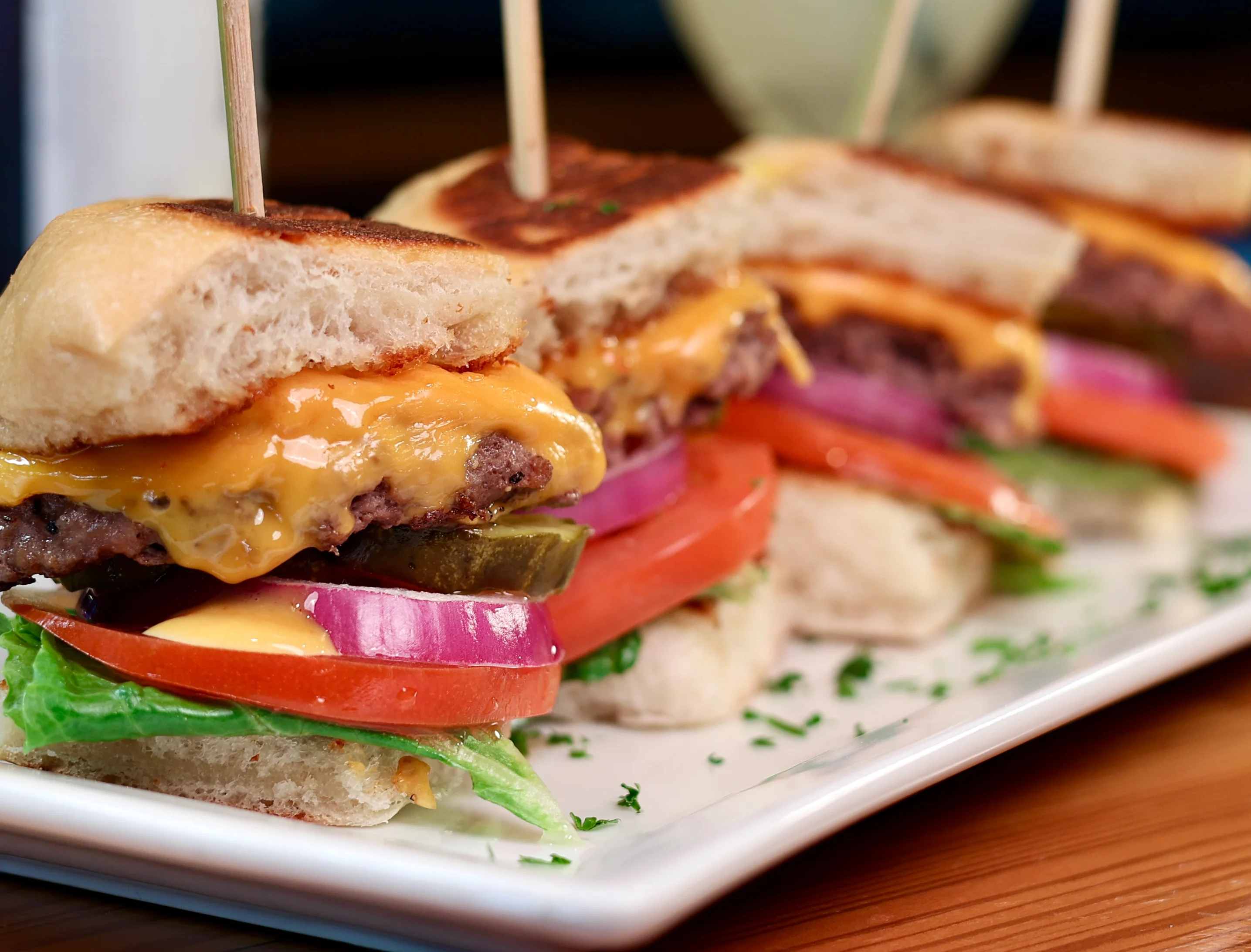 Delicious gourmet burger with fresh toppings on a wooden table